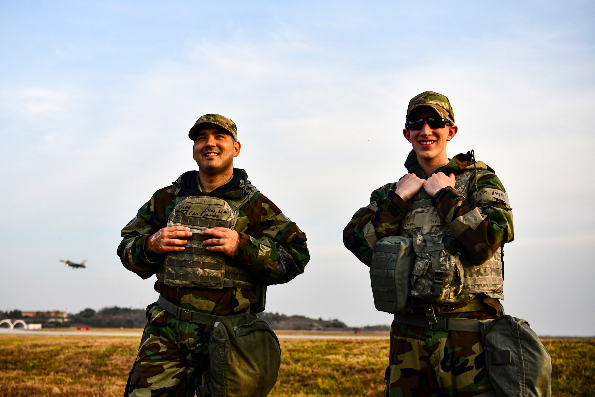 Airmen smile near the flightline.