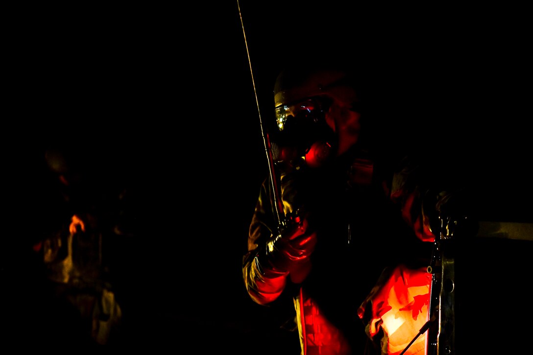 An Airman uses a radio.