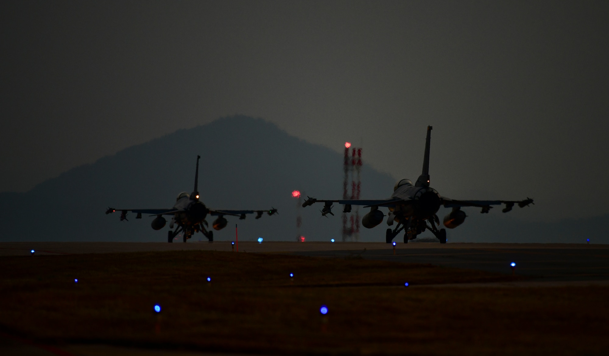 Two F-16 Fighting Falcons taxi and prepare for takeoff during routine training at Kunsan Air Base, Republic of Korea, Nov. 3, 2021. The F-16 is a compact, multi-role fighter aircraft, capable of highly maneuverable air-to-air combat and air-to-surface attack. (U.S. Air Force photo by Staff Sgt. Jesenia Landaverde)