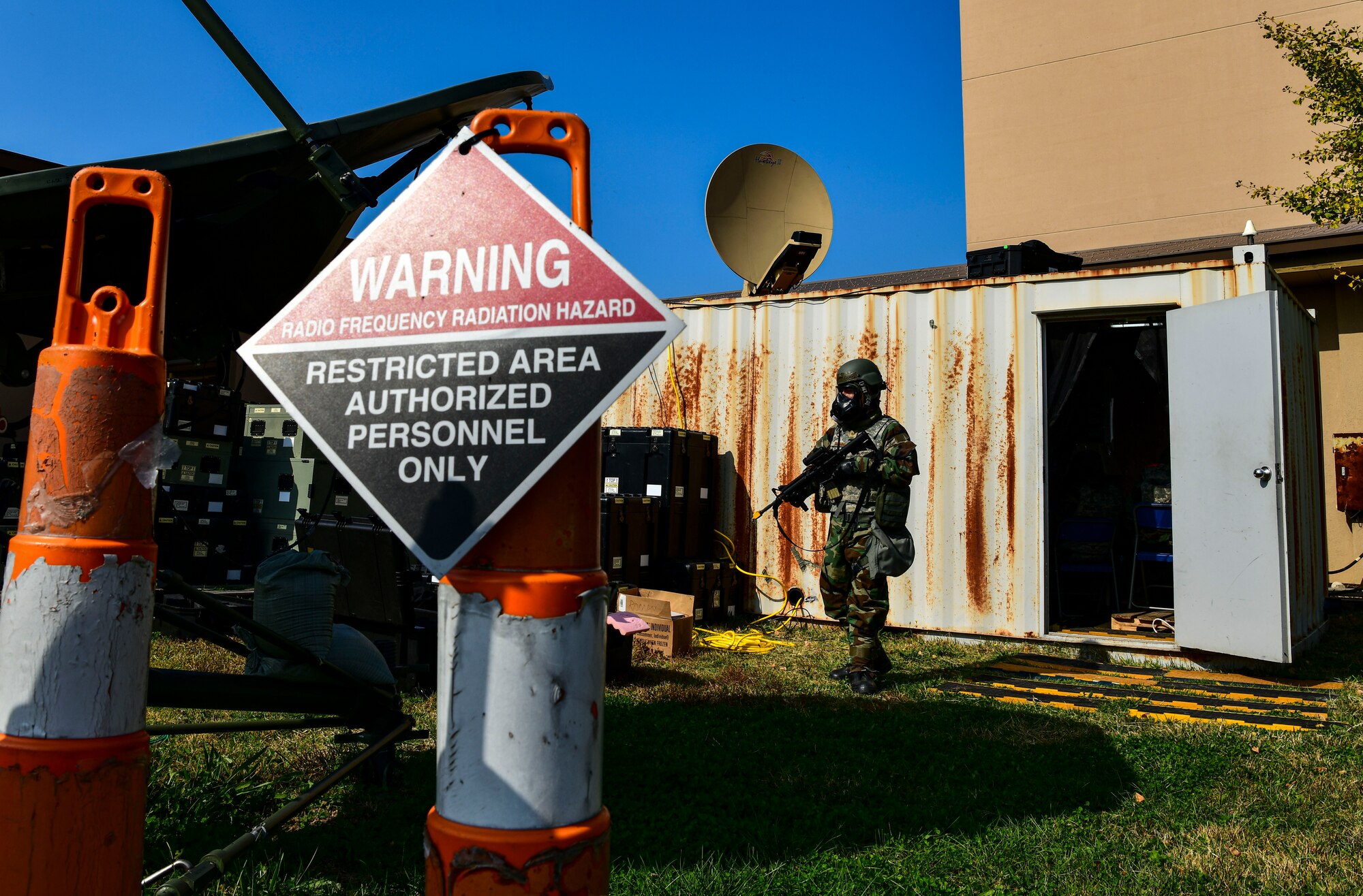 Technical Sgt. Christopher Rushner, 8th Communications Squadron noncommissioned officer in charge of network management and door guard, secures the area at Kunsan Air Base, Republic of Korea, Nov 3. 2021. The communication squadron tested their ability to setup a remote network access that provides secure data anywhere, any time. (U.S. Air Force photo by Staff Sgt. Jesenia Landaverde)