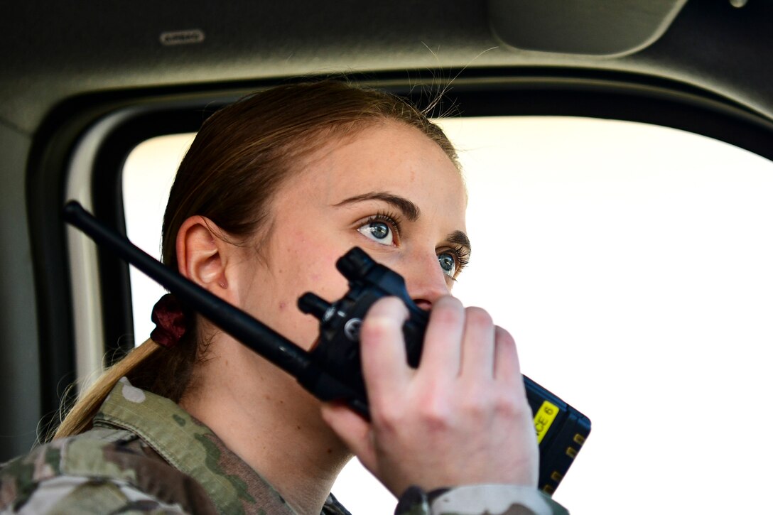 An Airman uses a radio.