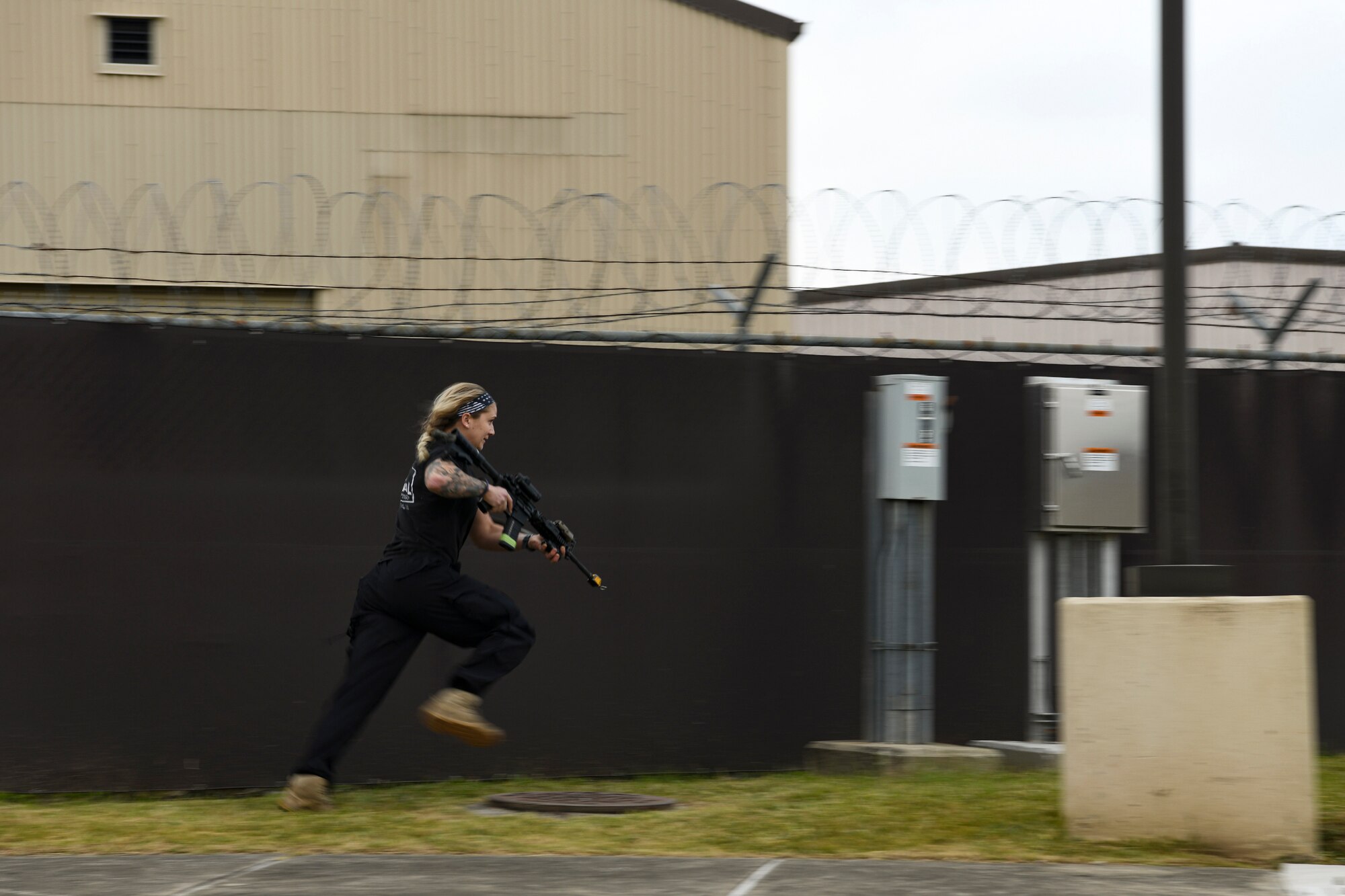 U.S. Air Force Staff Sgt. Andrea Dickel, 8th Security Forces Squadron defender and simulated trespasser, runs through a gate entry during a routine training event at Kunsan Air Base, Republic of Korea, Nov. 1, 2021. The Kunsan defenders are consistently training on their efficiency on base defense, leading to successfully locating and apprehending the simulated trespassers. (U.S. Air Force photo by Staff Sgt. Jesenia Landaverde)