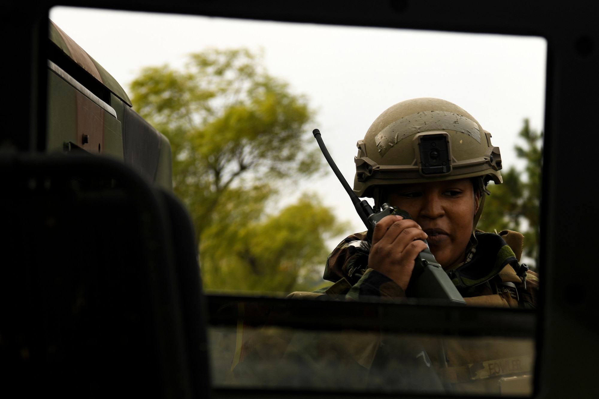 Staff Sgt. Shelby Fowler, 8th Security Forces Squadron investigator, makes a call on a land mobile radio during a routine training event at Kunsan Air Base, Republic of Korea, Nov. 1, 2021. The Kunsan defenders are constantly training on their efficiency on base defense, leading to successfully locating and apprehending the simulated trespassers. (U.S. Air Force photo by Staff Sgt. Jesenia Landaverde)