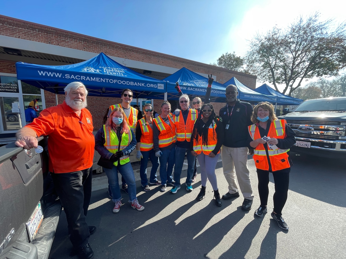 William D. King (processing supervisor), left,  and Wallace A. Oliver (human resources assistant), second to right,  are pictured with volunteers from Sacramento Food Bank & Family Services during the turkey drive on Nov. 12, 2021