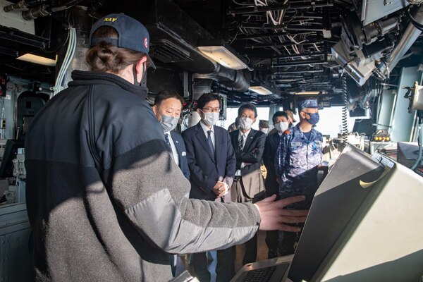 Lt. Cmdr. Avery Wilson, the navigator aboard the forward-deployed amphibious assault ship USS America (LHA 6), conducts a tour of the ship’s pilot house for local and regional civic and military leadership during a port visit to Marine Corps Air Station Iwakuni. America, lead ship of the America Amphibious Ready Group, is operating in the U.S. 7th Fleet area of responsibility to enhance interoperability with allies and partners and serve as a ready response force to defend peace and stability in the Indo-Pacific region.