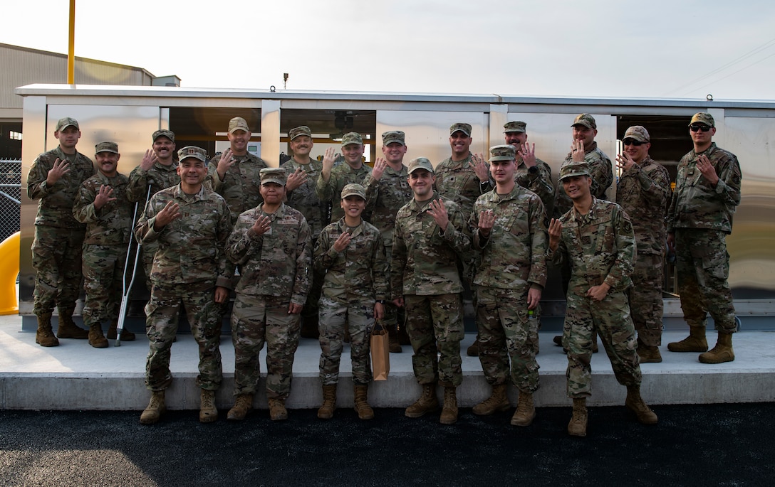 Eighth Civil Engineer Squadron Red Devils pose for a picture in front of the Natural Gas Governor during the Natural Gas Ribbon Cutting Ceremony at Kunsan Air Base, Republic of Korea, Nov. 15, 2021. The project was initiated in 2008 to address problems that many facilities experienced throughout the years and to improve the quality of life for members of the Wolf Pack. (U.S. Air Force photo by Staff Sgt. Suzie Plotnikov)