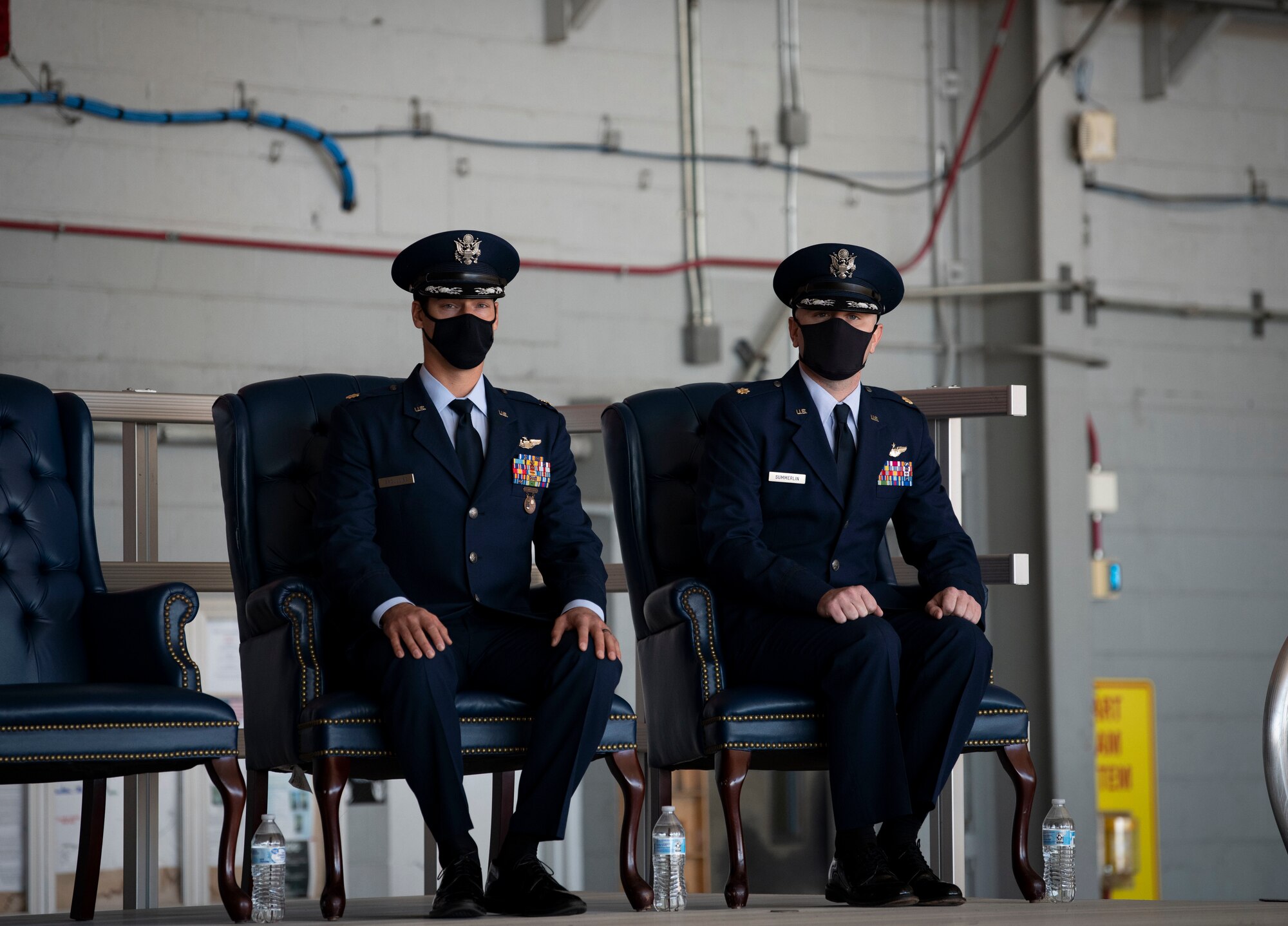 U.S. Air Force Maj. Jacob G. Broullire, left, and U.S. Air Force Maj. Christopher B. Summerlin, right, 15th Expeditionary Special Operations Squadron MC-130H Combat Talon II aircraft commanders, prepare to take center stage during a Distinguished Flying Cross presentation ceremony at Hurlburt Field, Florida, Nov. 8, 2021.