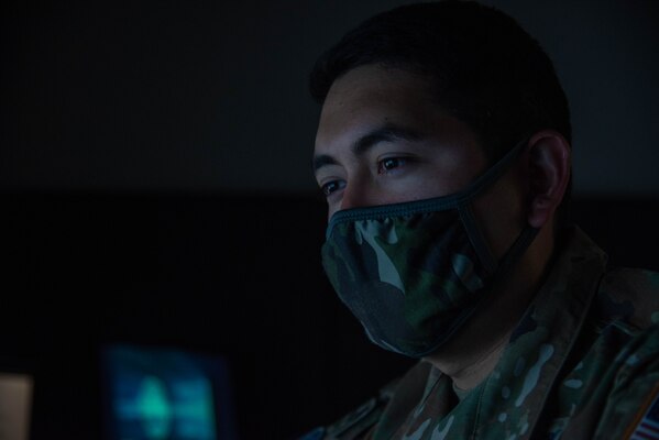 U.S. Space Force 1st Lt. wearing a mask looking at computer