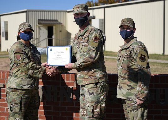 U.S. Air Force Col. Angelina Maguinness, 17th Training Group commander, presents 2nd Lt. Jeffery Cook, 315th Training Squadron student, the 17th TRG Rope of the Month award for October 2021, on Goodfellow Air Force Base, Texas, Nov. 19, 2021. Cook exhibited his dedication to his squadron and the training he received at Goodfellow. (U.S. Air Force photo by Airman 1st Class Sarah Williams)
