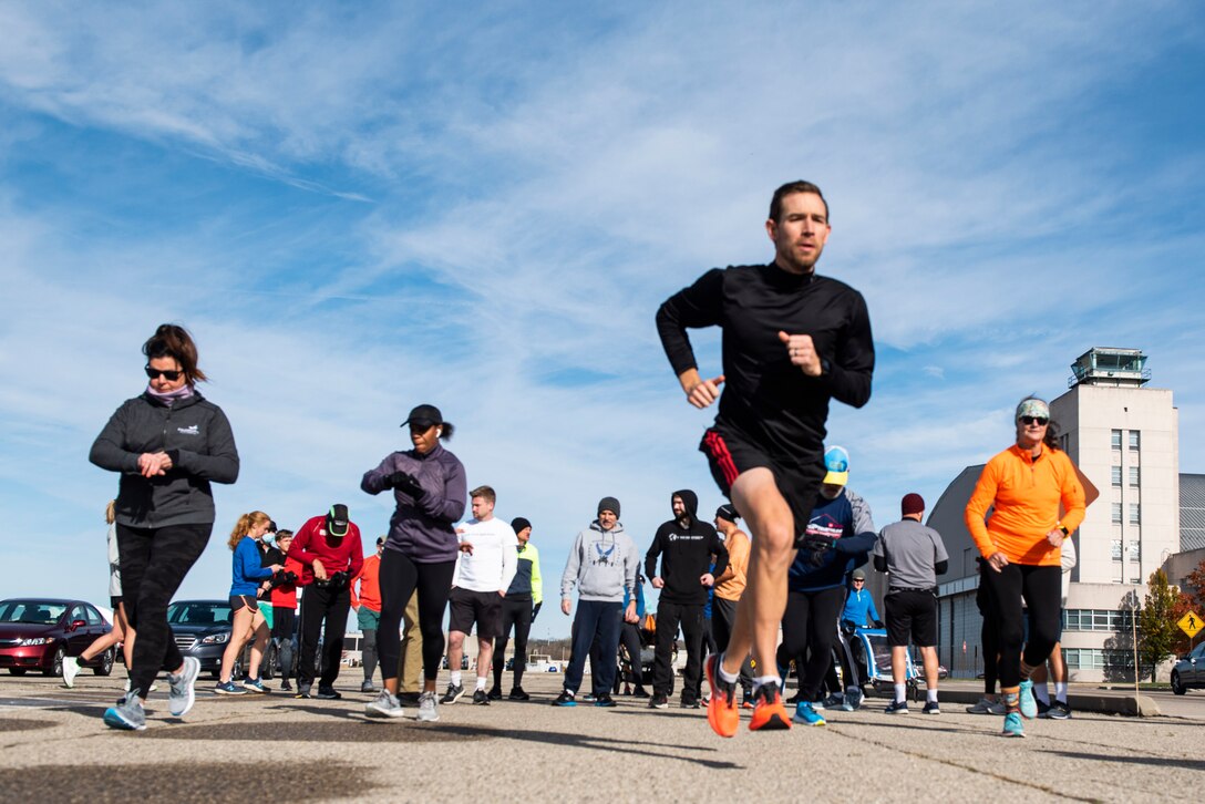 Participants take off from the starting line of the 88th Force Support Squadron’s Turkey Trot 5k Fun Run at Wright-Patterson Air Force Base, Ohio, Nov. 18, 2021. Due to COVID runners were released in waves of 10 this year to help with social distancing. (U.S. Air Force photo by Wesley Farnsworth)