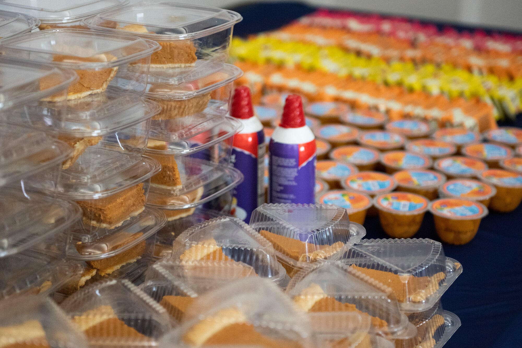 A table full of pumpkin pie slices, fruit cups and protein bars, wait for runners participating in the 88th Force Support Squadron’s Turkey Trot 5k Fun Run inside the Wright Field Fitness Center Nov. 18, 2021, at Wright-Patterson Air Force Base, Ohio. Due to COVID, runners were released in waves of 10 this year to help with social distancing. (U.S. Air Force photo by Wesley Farnsworth)