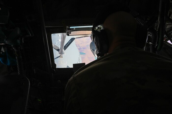 U.S. Air Force Tech. Sgt. Andrew Valence, 54th Air Refueling Squadron boom operator instructor, refuels a C-17 Globemaster III from a KC-135 Stratotanker, Nov. 15, 2021. One C-17 and one KC-46 Pegasus from Altus Air Force Base, Oklahoma, used for air refueling training throughout the first two days of the exercise. (U.S. Air Force photo by Airman 1st Class Kayla Christenson)
