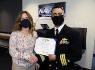 IMAGE: Naval Surface Warfare Center Dahlgren Division Dam Neck Activity (NSWCDD DNA) Commanding Officer Cmdr. Michael Aiena presents Kelly Goodman with a Department of Navy Civilian Service Achievement Medal Oct. 13, in Virginia Beach, Virginia. Goodman, NSWCDD DNA chief information officer and Information Technology division head, received the award for providing exemplary leadership in preparing her division for a triennial Immediate Superior in Command-led Inspector General audit of the division's Cybersecurity programs.