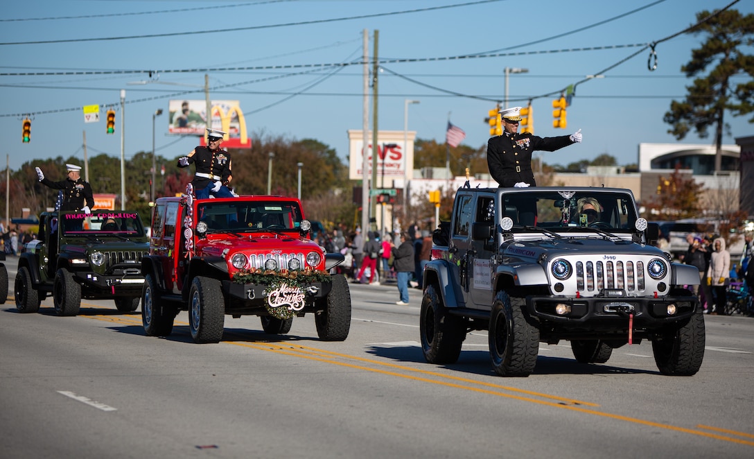 Leaders from Marine Corps Installations East-MCB Camp Lejeune and MCAS New River participate in the 2021 Christmas Holiday Parade in Jacksonville, North Carolina, Nov. 20, 2021.