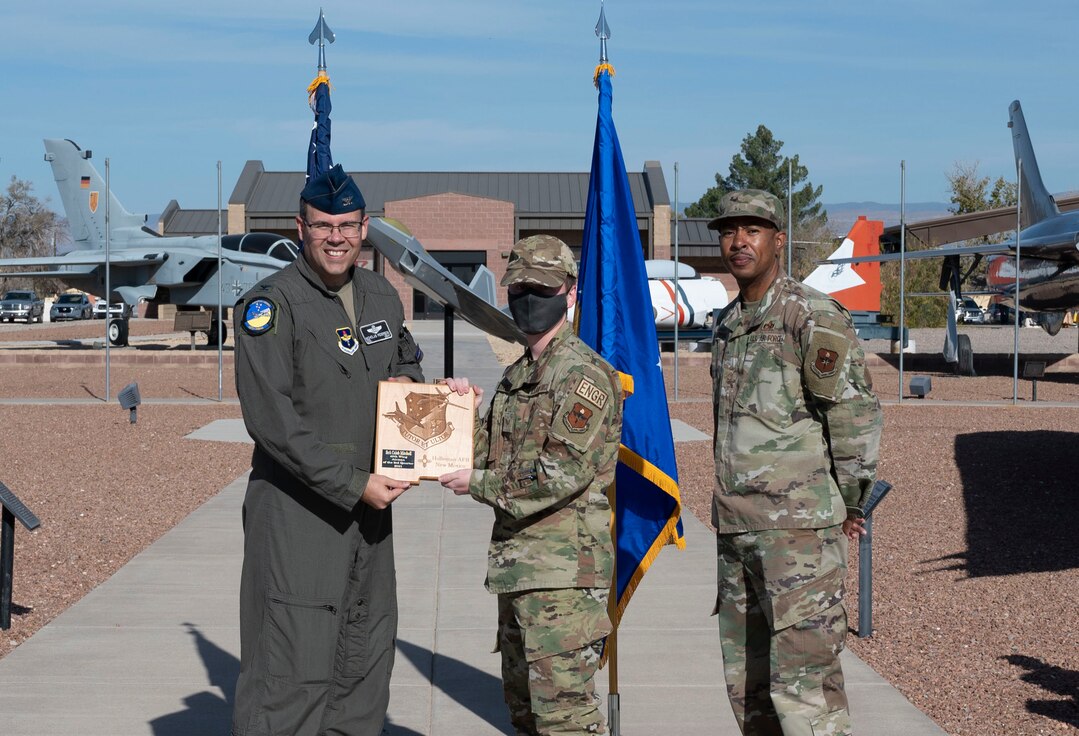Senior Airman Caleb Mitchell, quarterly award winner, accepts the 49th Wing airman of the quarter award during the 49th Wing’s 3rd quarter award ceremony, Nov. 19, 2021, on Holloman Air Force Base, New Mexico. Quarterly award winners were selected based on their technical expertise, demonstration of leadership and job performance. (U.S. Air Force photo by Airman 1st Class Antonio Salfran)