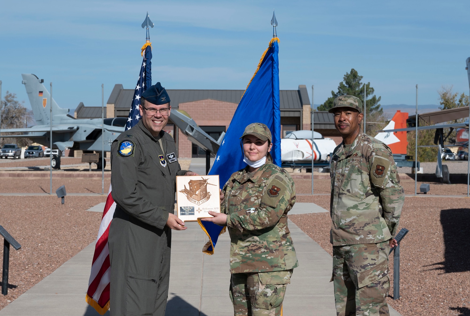 Tech. Sgt. Jennifer Orr, quarterly award winner, accepts the noncommissioned officer of the quarter award during the 49th Wing’s 3nd quarter award ceremony, Nov. 19, 2021, on Holloman Air Force Base, New Mexico. Quarterly award winners were selected based on their technical expertise, demonstration of leadership and job performance. (U.S. Air Force photo by Airman 1st Class Antonio Salfran)