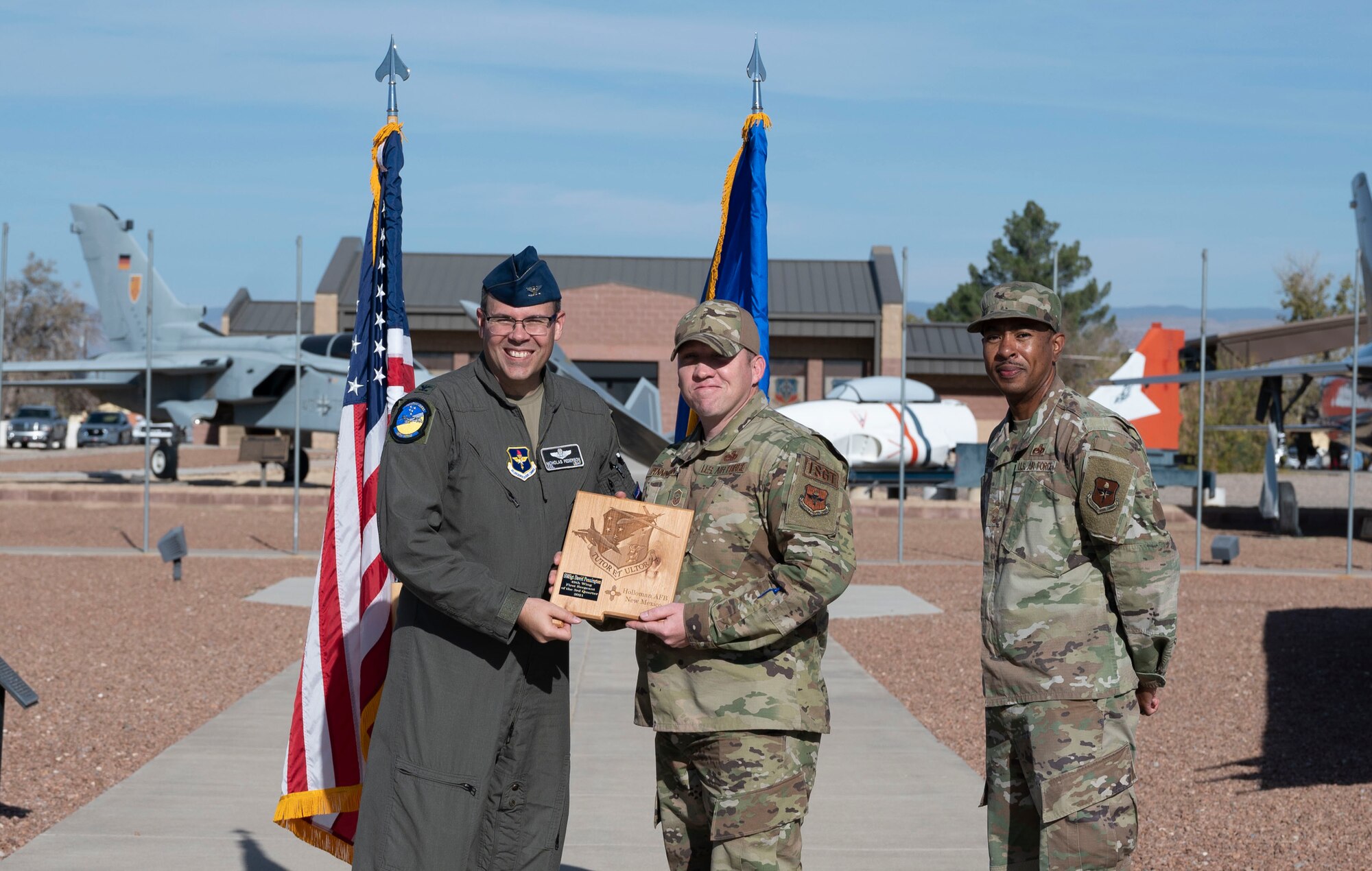 Senior Master Sgt. David Pennington, quarterly award winner, accepts the First Sergeant of the quarter award during the 49th Wing’s 3rd quarter award ceremony, Nov. 19, 2021, on Holloman Air Force Base, New Mexico. Quarterly award winners were selected based on their technical expertise, demonstration of leadership and job performance. (U.S. Air Force photo by Airman 1st Class Antonio Salfran)
