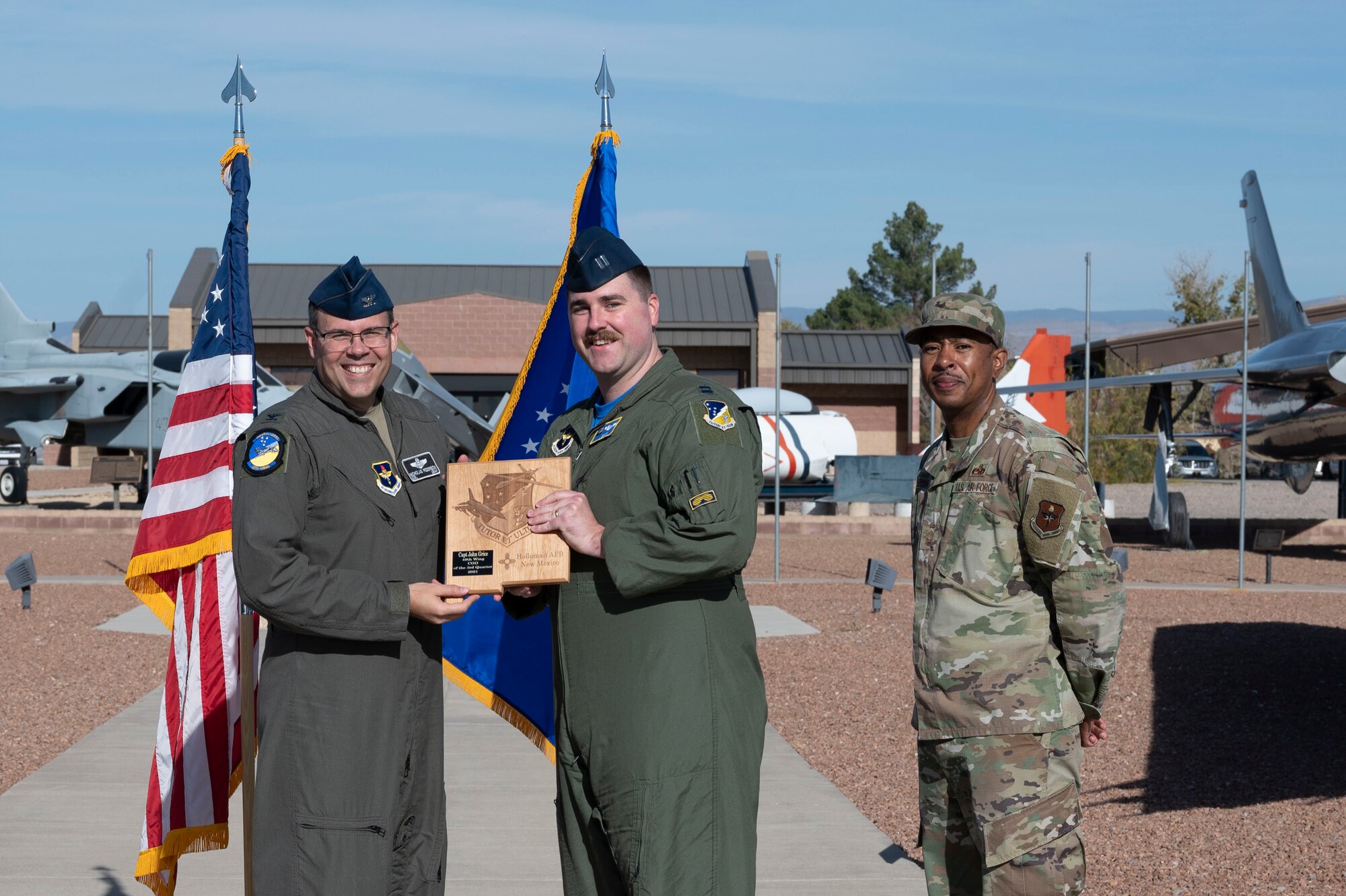 Capt. John Grice, quarterly award winner, accepts the Company Grade Officer of the quarter award during the 49th Wing’s 3rd quarter award ceremony, Nov. 19, 2021, on Holloman Air Force Base, New Mexico. Quarterly award winners were selected based on their technical expertise, demonstration of leadership and job performance. (U.S. Air Force photo by Airman 1st Class Antonio Salfran)