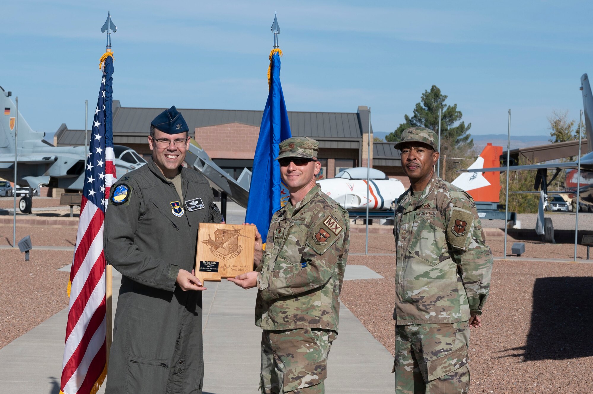 Maj. Donald Bolda, quarterly award winner, accepts the Field Grade Officer of the quarter award during the 49th Wing’s 3rd quarter award ceremony, Nov. 19, 2021, on Holloman Air Force Base, New Mexico. Quarterly award winners were selected based on their technical expertise, demonstration of leadership and job performance. (U.S. Air Force photo by Airman 1st Class Antonio Salfran)
