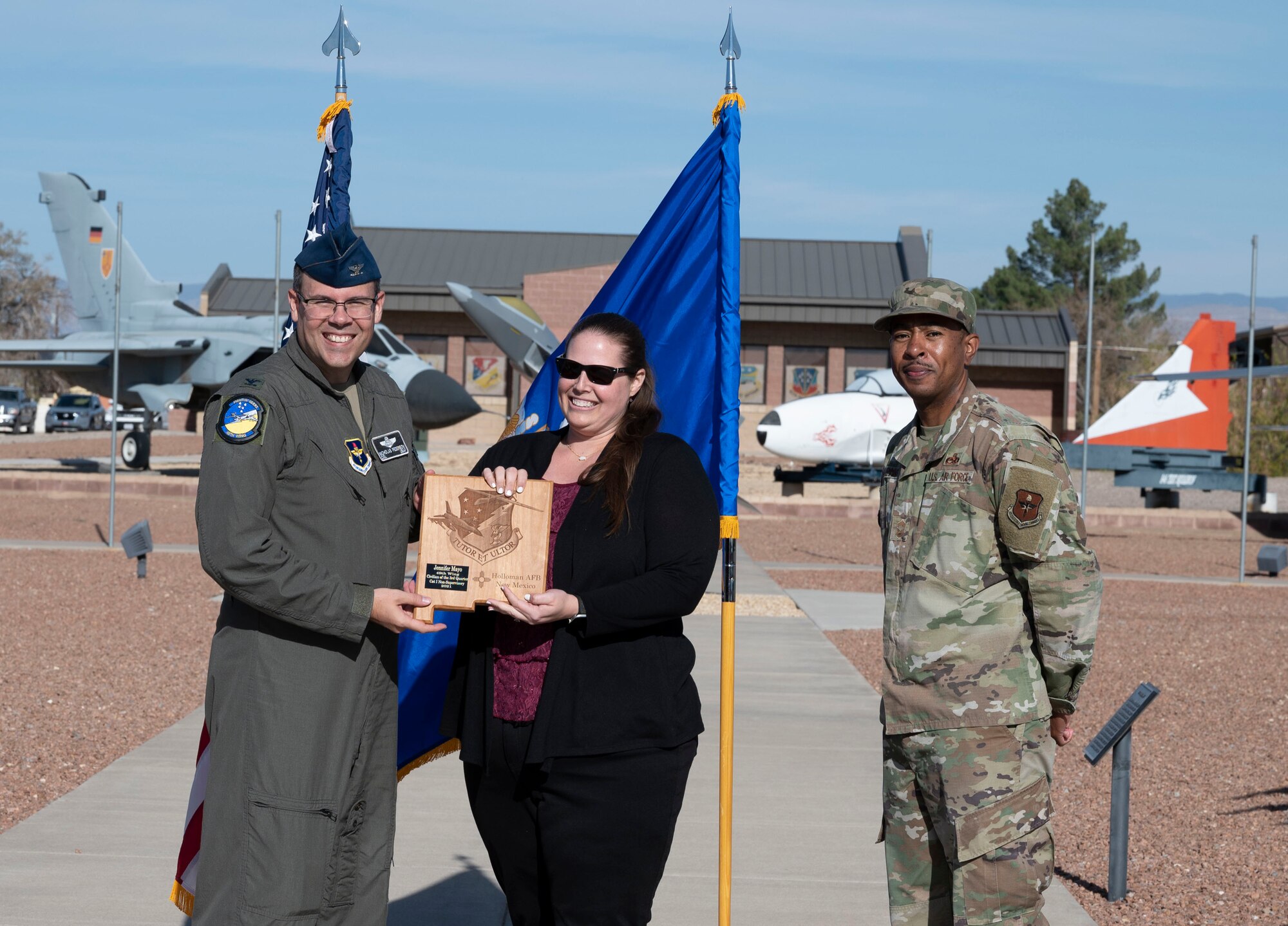 Jennifer Mayo, quarterly award winner, accepts the Civilian Category I Non-Supervisory of the quarter award during the 49th Wing’s 3rd quarter award ceremony, Nov. 19, 2021, on Holloman Air Force Base, New Mexico. Quarterly award winners were selected based on their technical expertise, demonstration of leadership and job performance. (U.S. Air Force photo by Airman 1st Class Antonio Salfran)