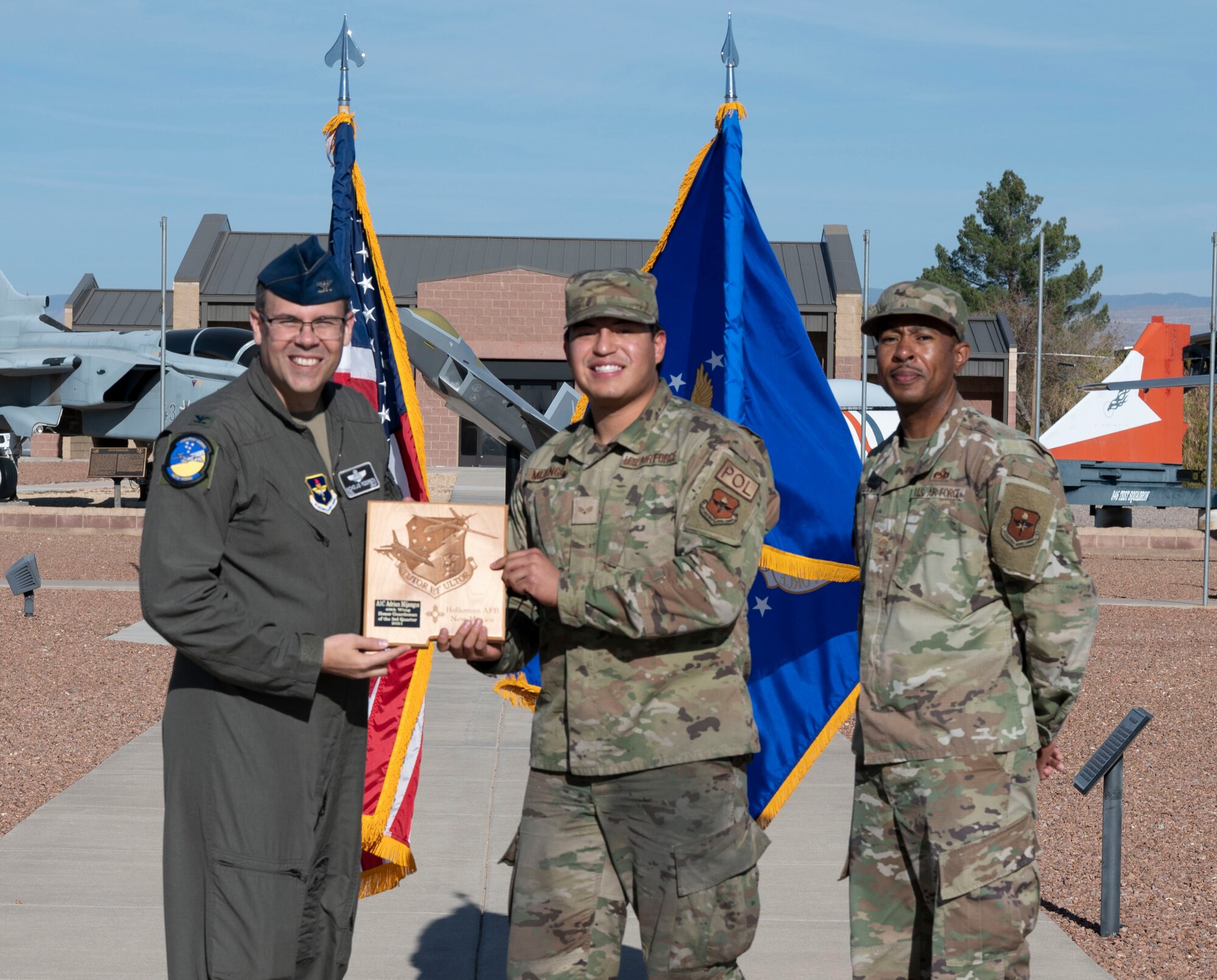 Senior Airman Adrian Mijangos, quarterly award winner, accepts the Honor Guardsman of the quarter award during the 49th Wing’s 3rd quarter award ceremony, Nov. 19, 2021, on Holloman Air Force Base, New Mexico. Quarterly award winners were selected based on their technical expertise, demonstration of leadership and job performance. (U.S. Air Force photo by Airman 1st Class Antonio Salfran)