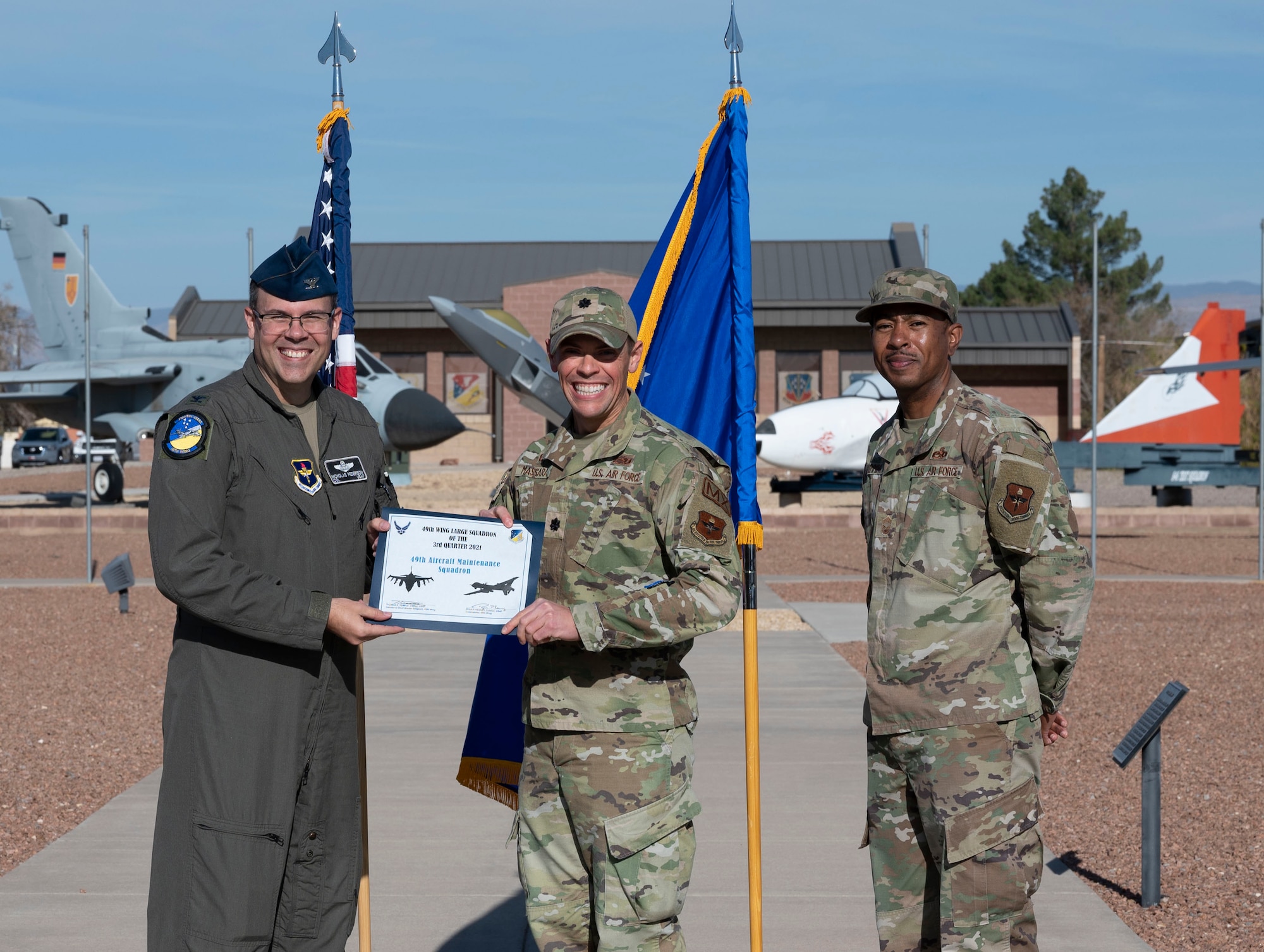 A representative from the 49th Aircraft Maintenance Squadron accepts the large unit of the quarter award during the 49th Wing’s 3rd quarter award ceremony, Nov. 19, 2021, on Holloman Air Force Base, New Mexico. Quarterly award winners were selected based on their technical expertise, demonstration of leadership and job performance. (U.S. Air Force photo by Airman 1st Class Antonio Salfran)