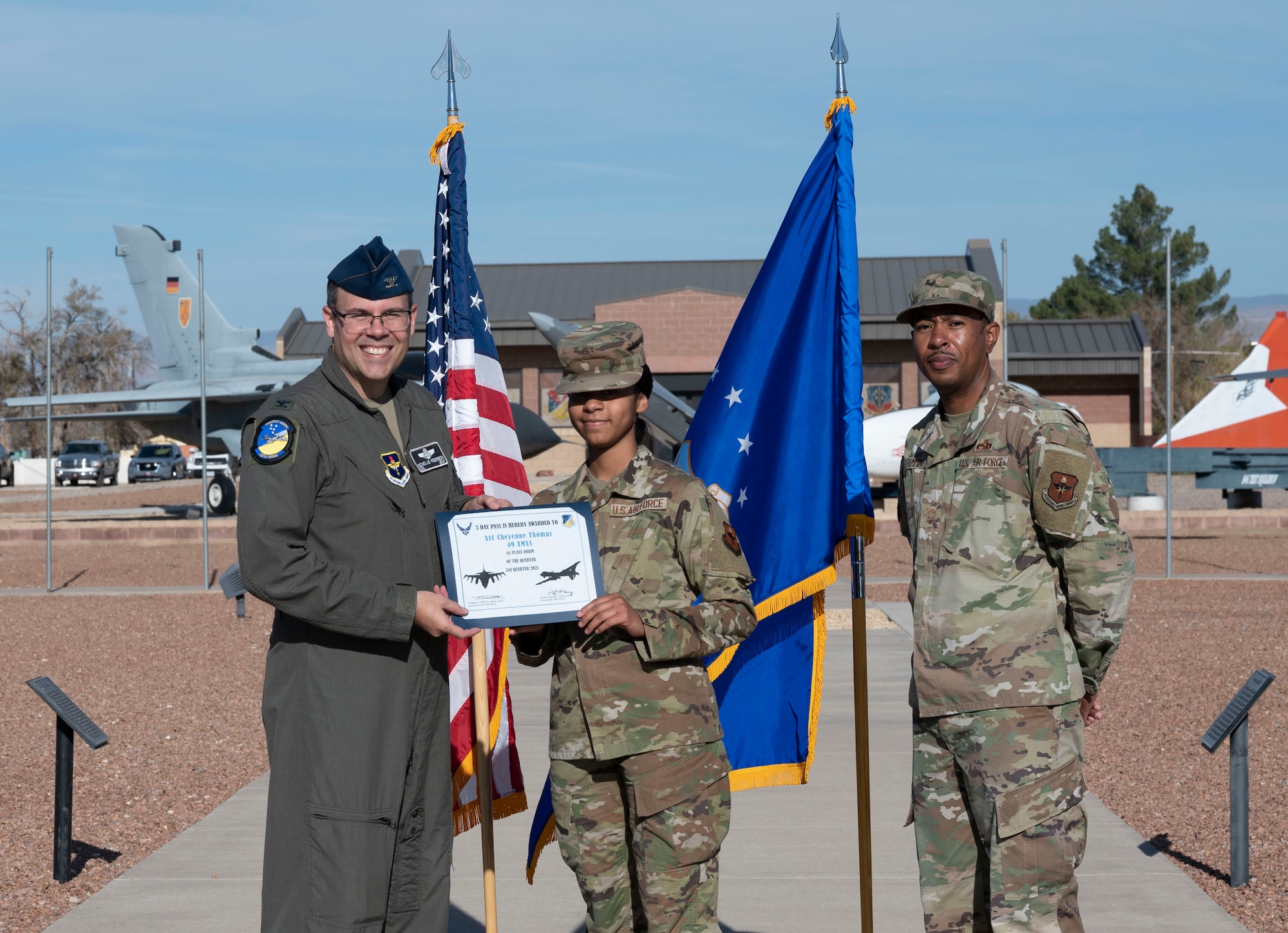 Airman 1st Class Cheyenne Thomas, quarterly award winner, accepts the Dorm of the quarter award during the 49th Wing’s 3rd quarter award ceremony, Nov. 19, 2021, on Holloman Air Force Base, New Mexico. Quarterly award winners were selected based on their technical expertise, demonstration of leadership and job performance. (U.S. Air Force photo by Airman 1st Class Antonio Salfran)