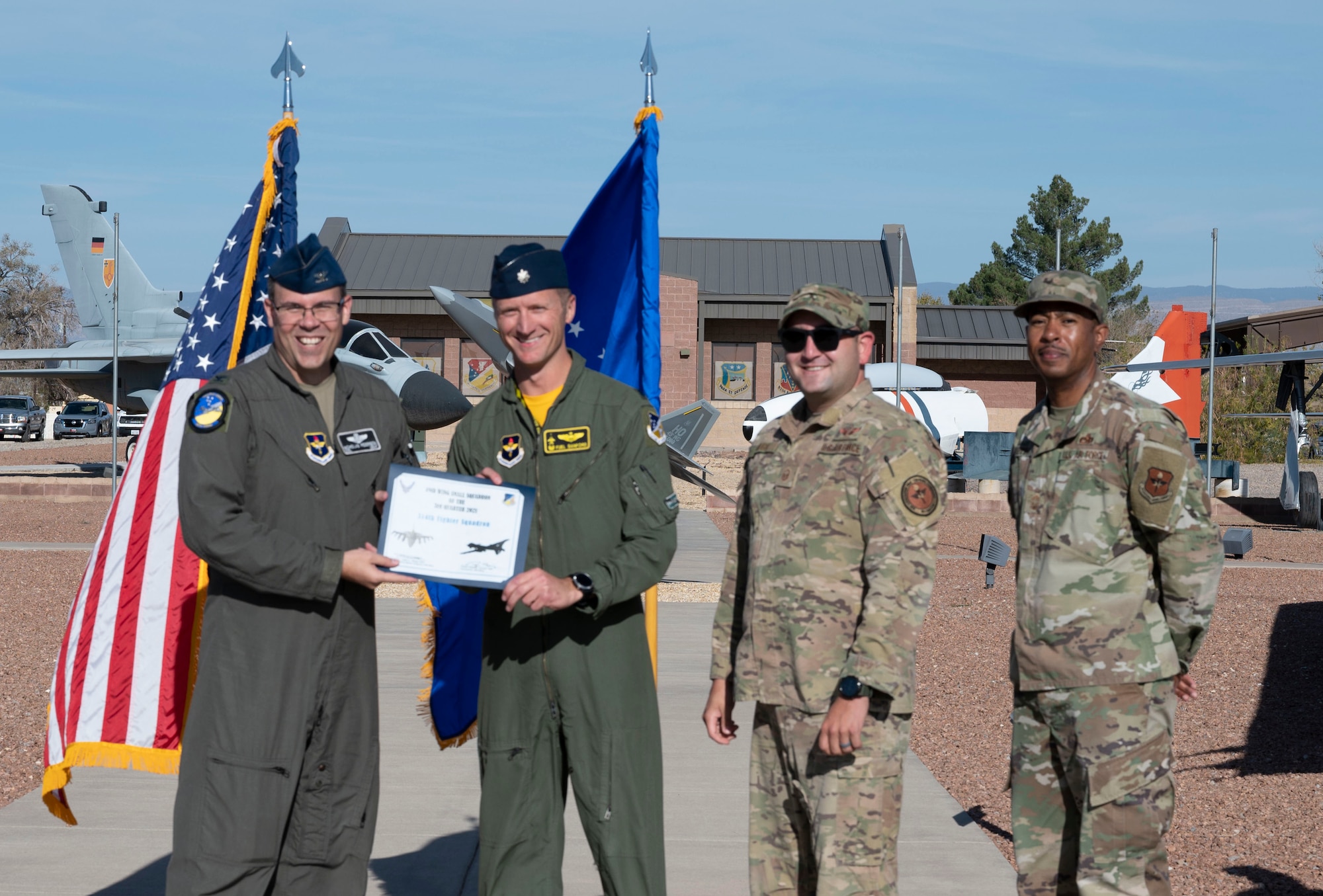 Representatives from the 314th Fighter Squadron accept the small unit of the quarter award during the 49th Wing’s 3rd quarter awards ceremony, Nov. 19, 2021, on Holloman Air Force Base, New Mexico. Quarterly award winners were selected based on their technical expertise, demonstration of leadership and job performance. (U.S. Air Force photo by Airman 1st Class Antonio Salfran)