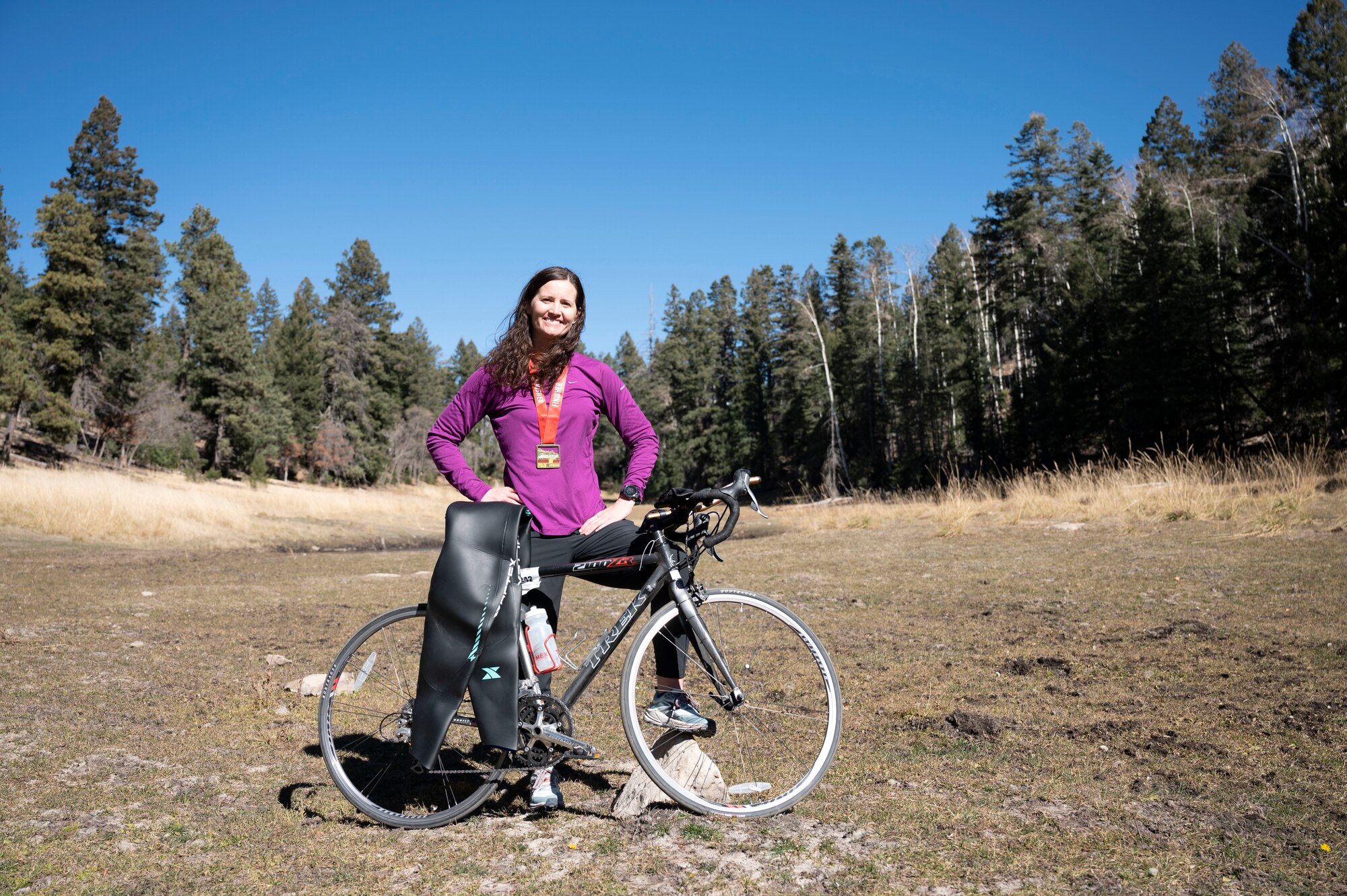 1st Lt. Ashley Corkins, 49th Wing junior executive officer, stands tall in the Lincoln National Forest in Cloudcroft, New Mexico, Nov. 13, 2021. To prepare for the lower elevation in Tempe, Arizona, where the triathlon was held, Corkins would train in areas with higher elevation to make certain she was properly acclimated. (U.S. Air Force photo by Airman 1st Class Antonio Salfran)