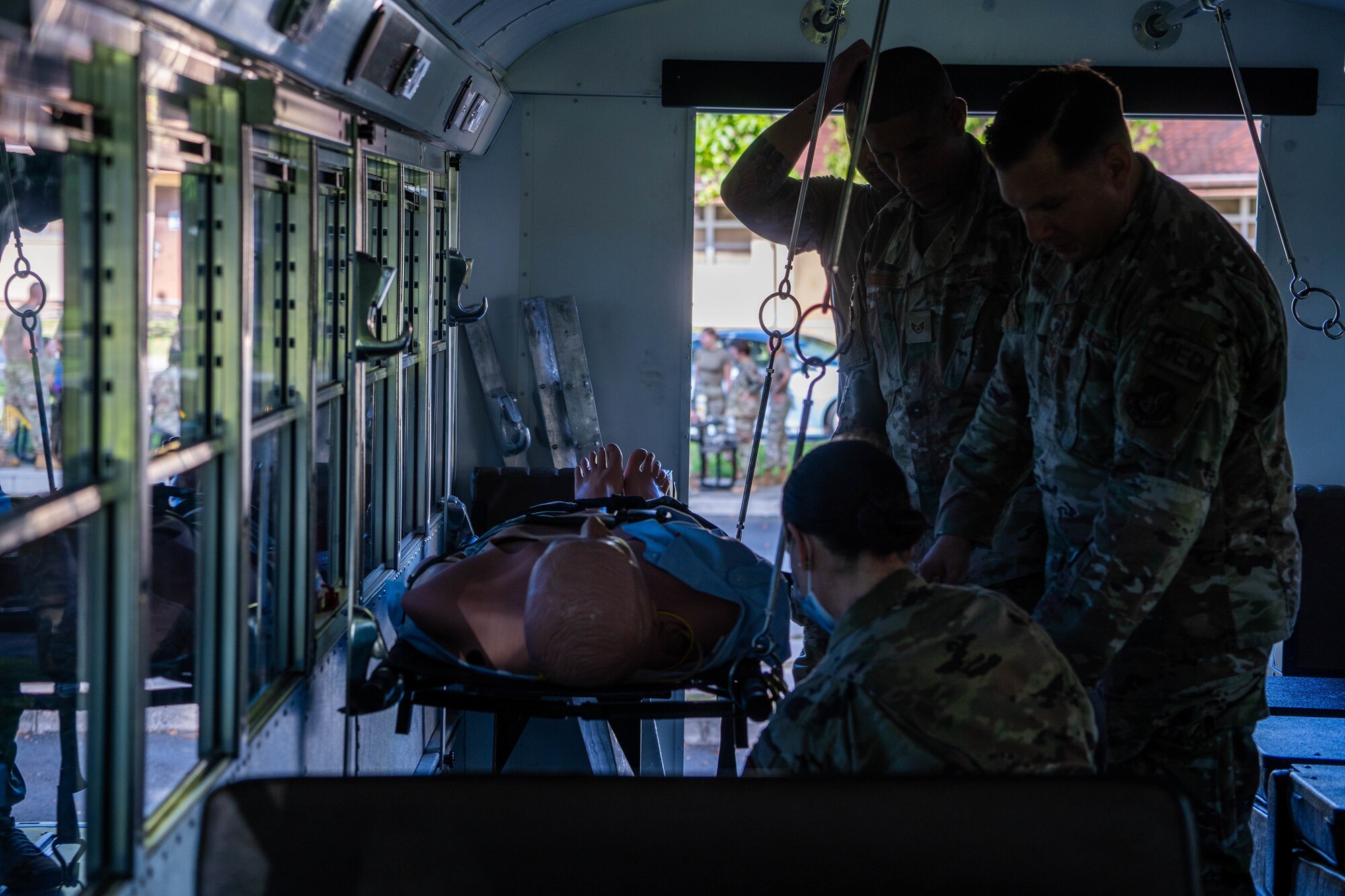 Airmen from the 15th Medical Group load a simulated patient onto a medical bus for transport during a mass-casualty exercise at Joint Base Pearl Harbor-Hickam, Hawaii, Nov. 18, 2021. A mass-casualty exercise is a realistic training opportunity for medics to utilize their medical training in a controlled environment to prepare to save lives and strengthen their crisis-response abilities. (U.S. Air Force photo by Airman 1st Class Makensie Cooper)