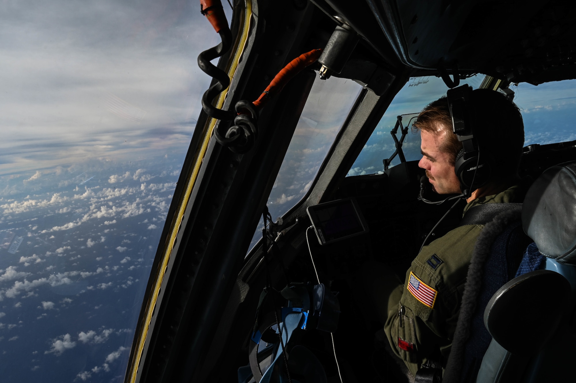 Capt. Alec Nelson, 535th Airlift Squadron C-17A Globemaster III aircraft commander, searches for two Royal Australian Air Force C-17s to form a three-ship formation during a training exercise over the West Pacific, Nov. 14, 2021. The United States Air Force and RAAF continuously train to strengthen their military-to-military relationship and provide regional security and stability within the Indo-Pacific region. (U.S. Air Force photo by Staff Sgt. Alan Ricker)
