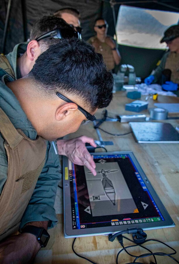 U.S. Marine Corps Sgt. Jose Gonzalez, an explosive ordnance disposal technician with Headquarters and Support Battalion, Marine Corps Installations Pacific, examines a projectile from an M136 Light Anti-Tank Weapon x-ray during a range exercise on Camp Schwab, Okinawa, Japan, Oct. 26, 2021. Picatinny Arsenal and the Expeditionary Systems Engineering Division came to the bomb exploitation range to give a period of instruction to U.S military combat engineers and EOD technicians regarding insight on exploitation theory, with different logistical perspectives. (U.S. Marine Corps photo by Lance Cpl. Jonathan Beauchamp)