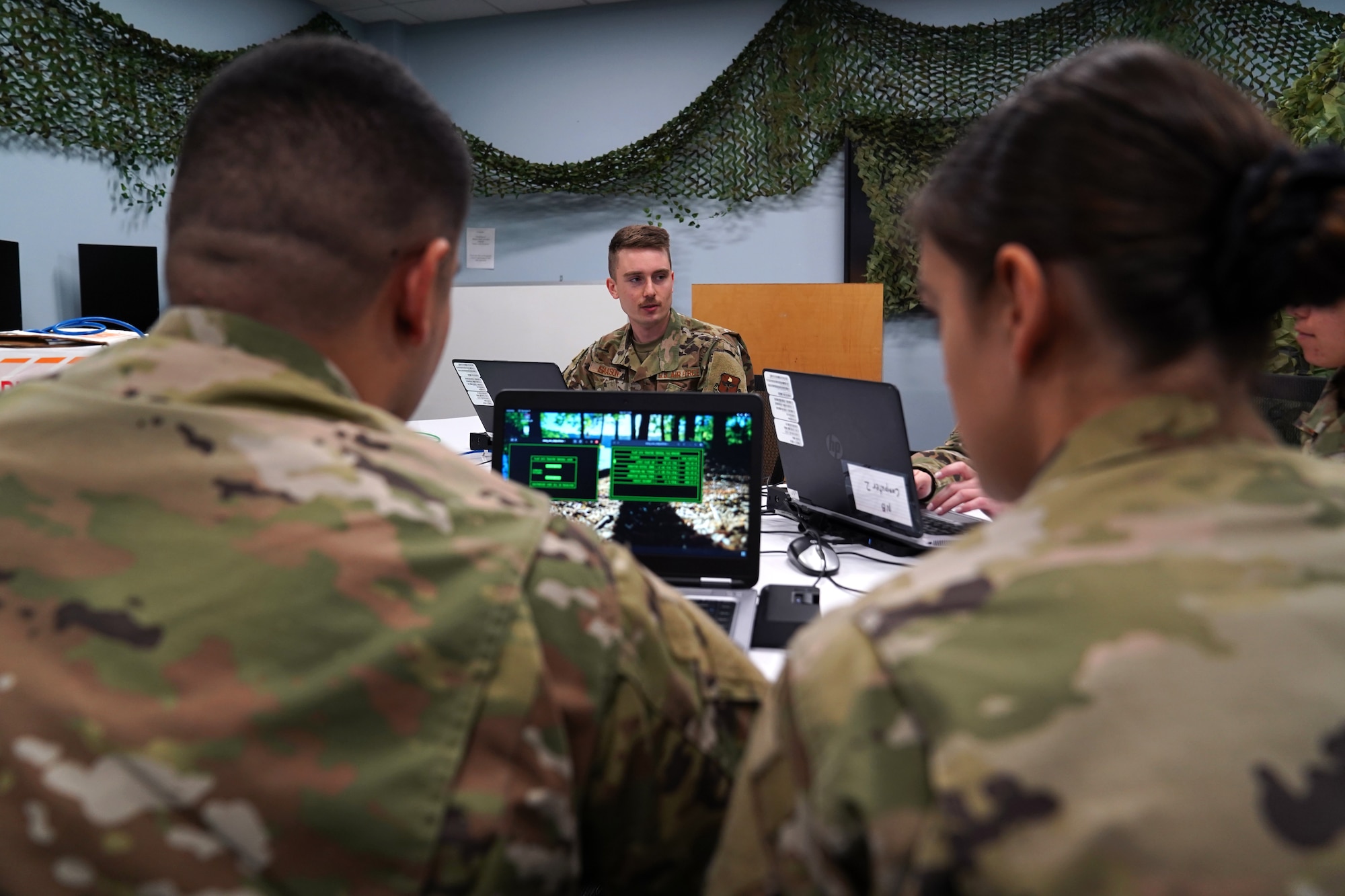 U.S. Space Force 2nd Lt. Anthony Gomez, U.S. Air Force 2nd Lt. Ethan Isaacson and 2nd Lt. Mackenzie Clay, 333rd Training Squadron cyber warfare officers, complete cyber tasks in the cyber escape room inside Stennis Hall at Keesler Air Force Base, Mississippi, November 10, 2021. The escape room was implemented into the squadron to test the capabilities of cyber warfare students and sharpen their skillset. (U.S. Air Force photo by Senior Airman Seth Haddix)