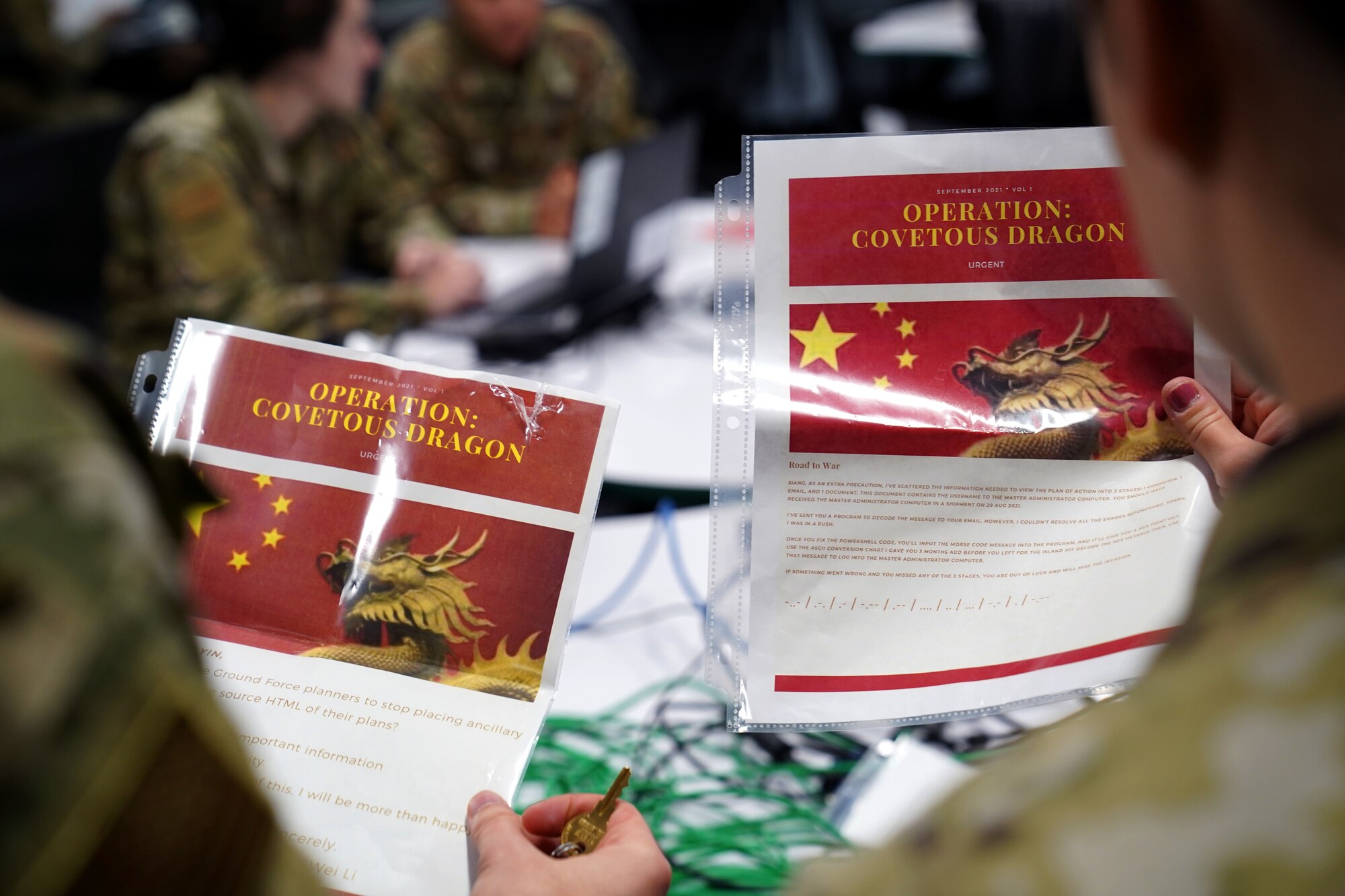 U.S. Air Force 2nd Lt. Ethan Isaacson and 2nd Lt. Mackenzie Clay, 333rd Training Squadron cyber warfare officers, examine clues in the cyber escape room inside Stennis Hall at Keesler Air Force Base, Mississippi, November 10, 2021. The escape room was implemented into the squadron to test the capabilities of cyber warfare students and sharpen their skillset. (U.S. Air Force photo by Senior Airman Seth Haddix)