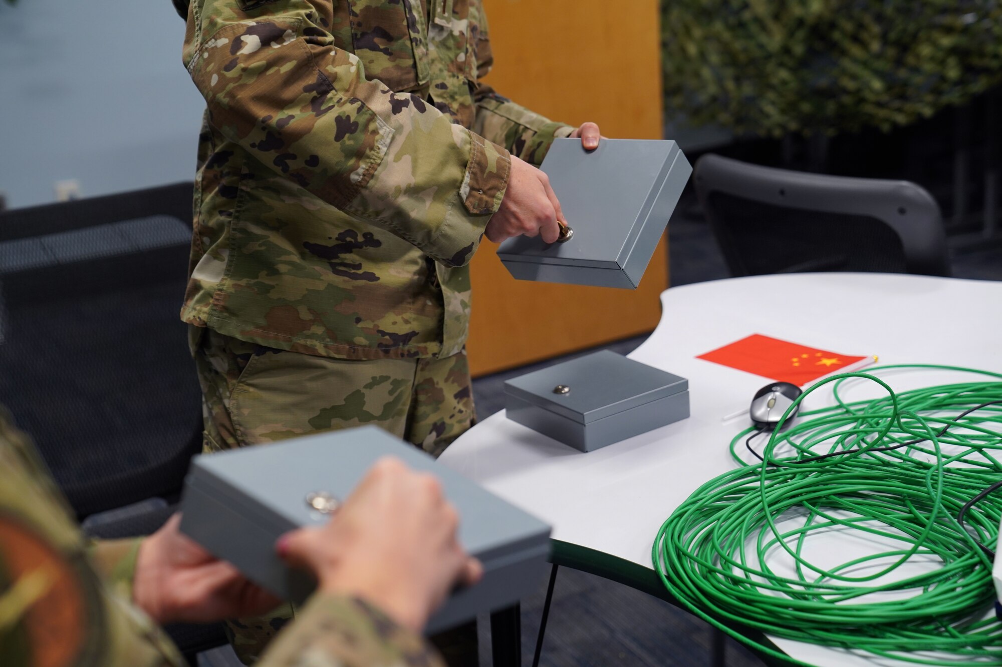 U.S. Air Force 2nd Lt. Ethan Isaacson and 2nd Lt. Mackenzie Clay, 333rd Training Squadron cyber warfare officers, use keys to open secure boxes in the cyber escape room inside Stennis Hall at Keesler Air Force Base, Mississippi, November 10, 2021. The escape room was implemented into the squadron to test the capabilities of cyber warfare students and sharpen their skillset. (U.S. Air Force photo by Senior Airman Seth Haddix)