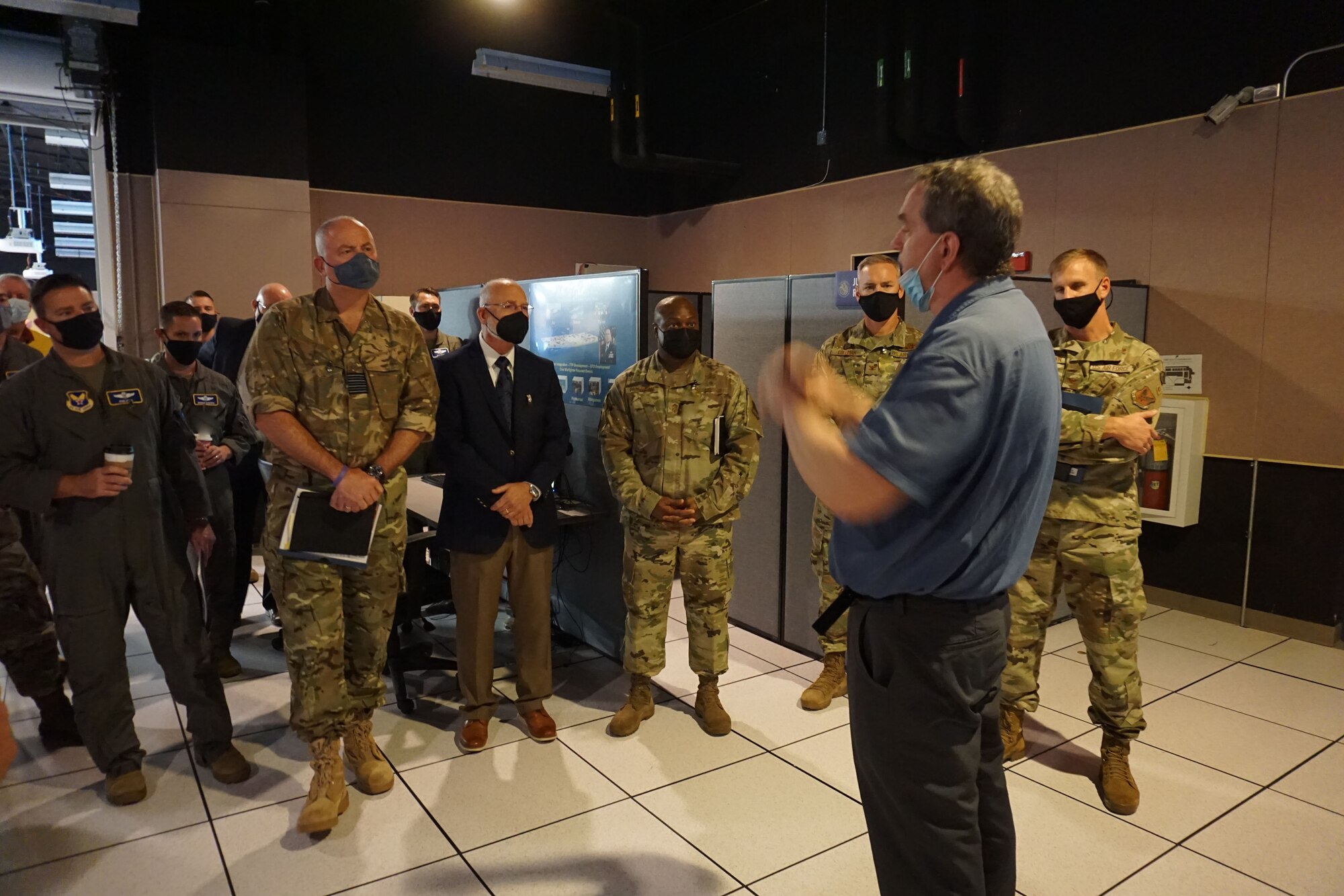 photo of man standing talking to a group