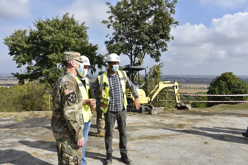 U.S. Army Corps of Engineers, Europe District Commander Col. Pat Dagon discusses ongoing parking lot improvement efforts with contractors on site on a plateau with office space at Longare, a mountainside military installation, during a visit to project sites at the installation October 4, 2021. The U.S. Army Corps of Engineers, Europe District is managing a $30 million construction and renovation program primarily funded by U.S. Army Intelligence and Security Command, U.S. Africa Command and U.S. Army Southern European Task Force, Africa to provide the 207th MIB(T) improved facilities at the Longare and Caserma Ederle portions of U.S. Army Garrison Italy. (U.S. Army photo by Chris Gardner)