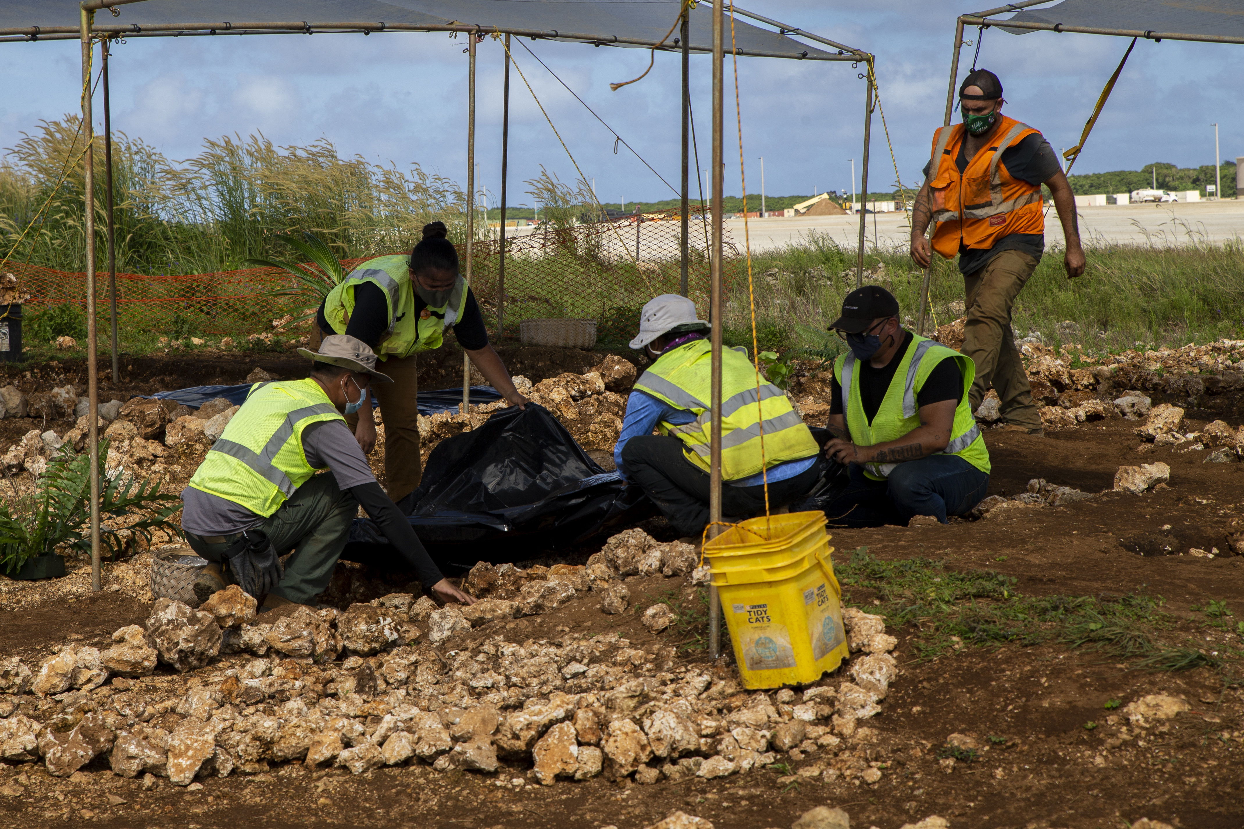 Archaeologists with Naval Facilities Engineering Systems Command Marianas uncover a burial mound during a cultural ritual at the Sabånan Fadang burial site on Marine Corps Base Camp Blaz, Nov. 23, 2021.