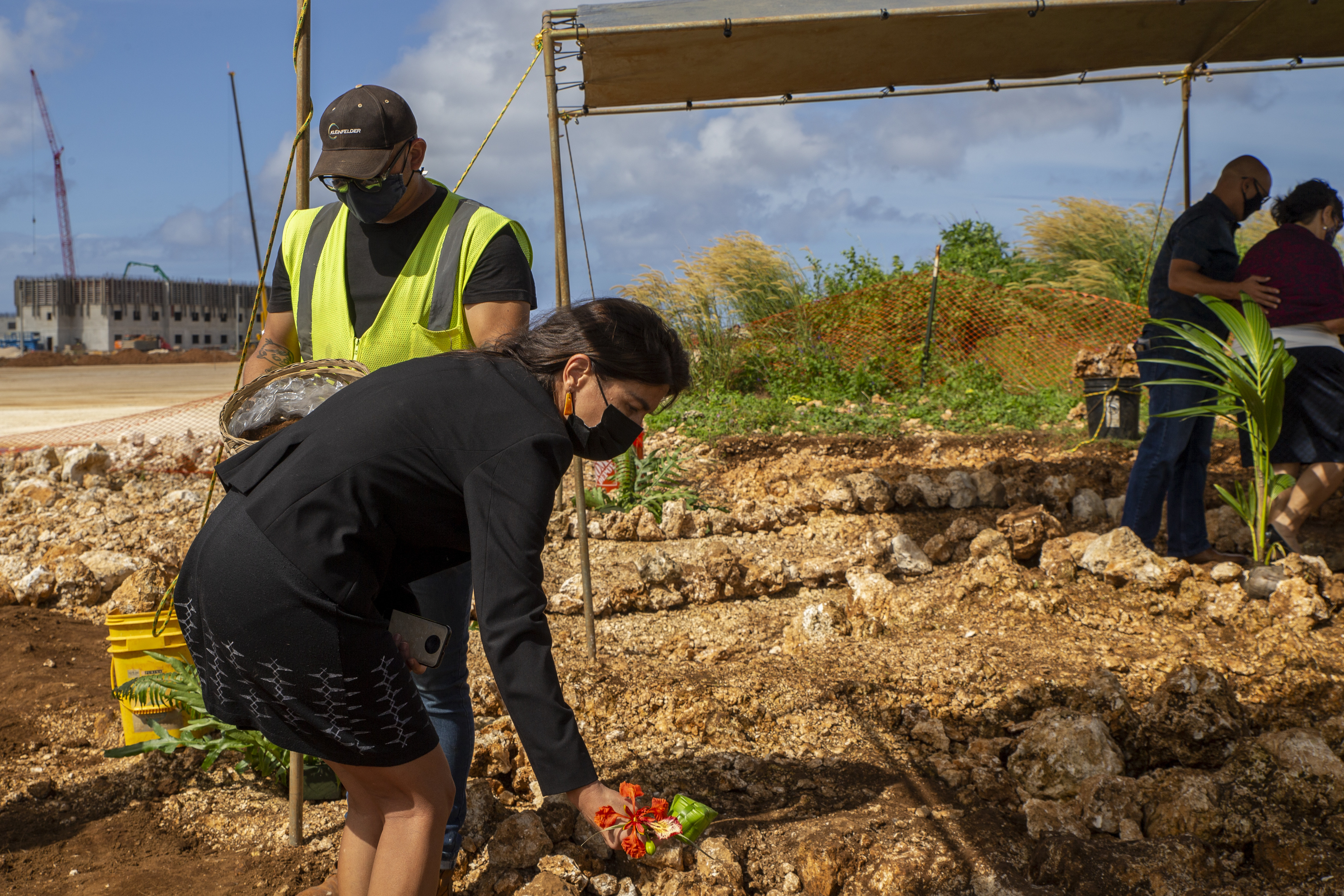 36th Guam Legislature Speaker Sen. Therese M. Terlaje, places a flower in a burial mound during a cultural ritual at the Sabånan Fadang burial site on Marine Corps Base Camp Blaz, Nov. 23, 2021.