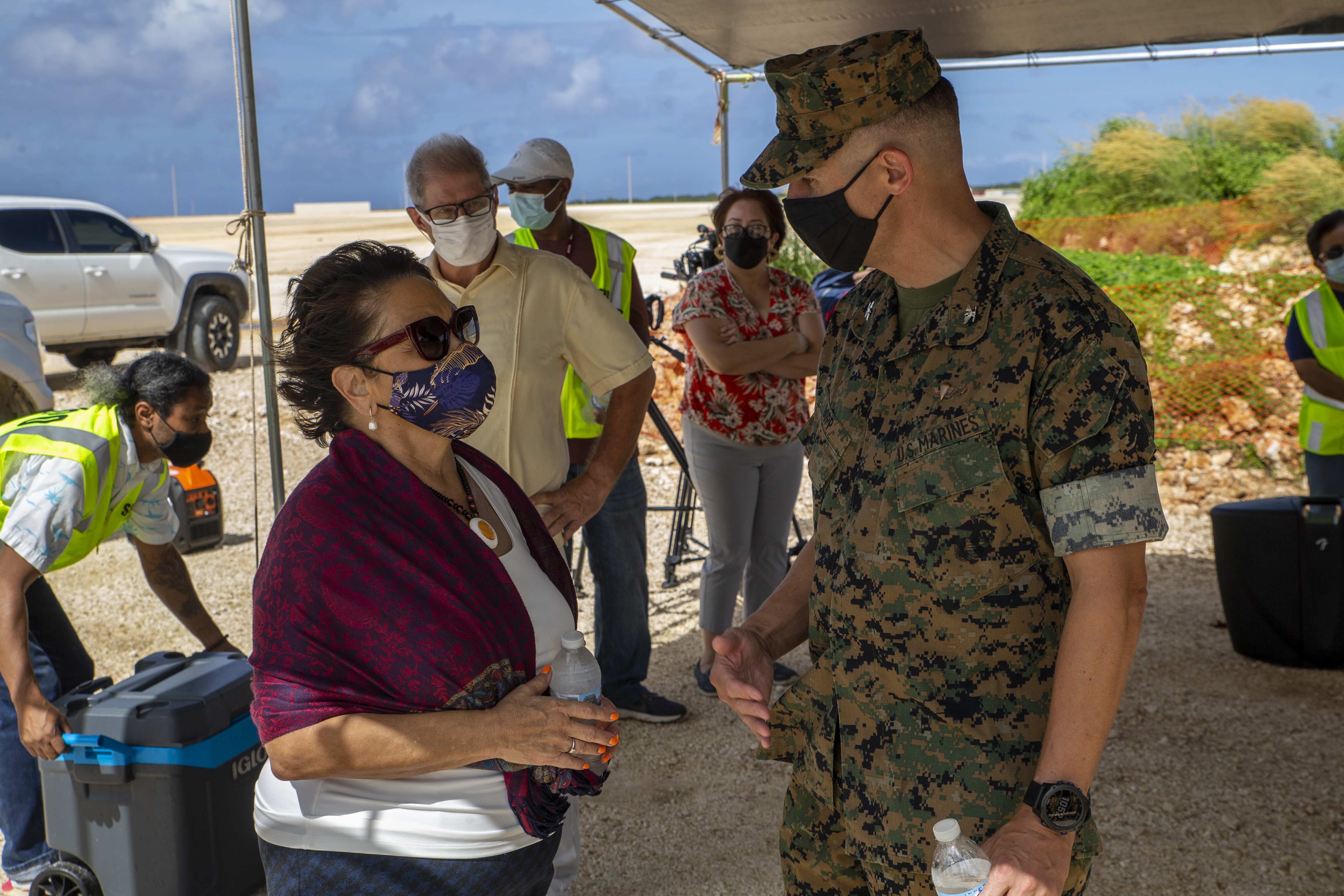 U.S. Marine Corps Col. Christopher Bopp, the Marine Corps Base (MCB) Camp Blaz commanding officer, speaks with the Honorable Lourdes Leon Guerrero, the governor of Guam, during a cultural ritual at the Sabånan Fadang burial site on MCB Camp Blaz, Nov. 23, 2021.