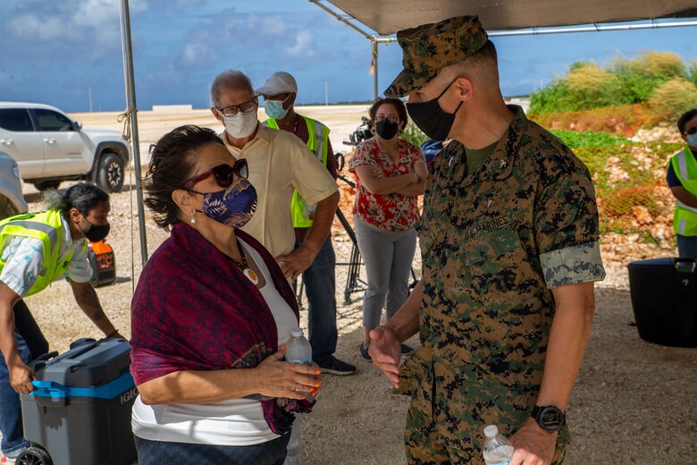 U.S. Marine Corps Col. Christopher Bopp, the Marine Corps Base (MCB) Camp Blaz commanding officer, speaks with the Honorable Lourdes Leon Guerrero, the governor of Guam, during a cultural ritual at the Sabånan Fadang burial site on MCB Camp Blaz, Nov. 23, 2021.