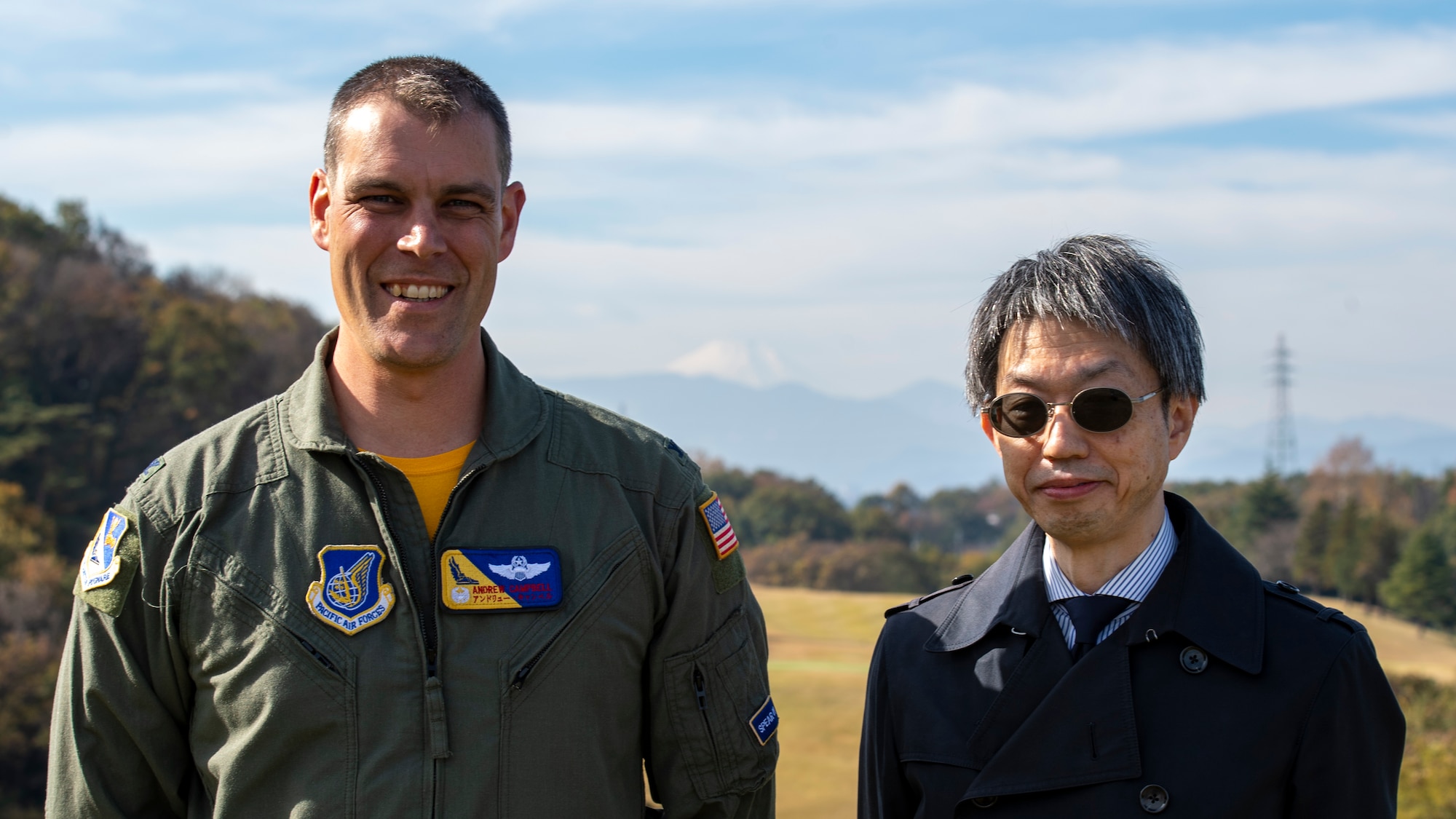 A U.S. Air Force Colonel and a local Japanese Government official pose for a photo with Mt. Fuji in the background.