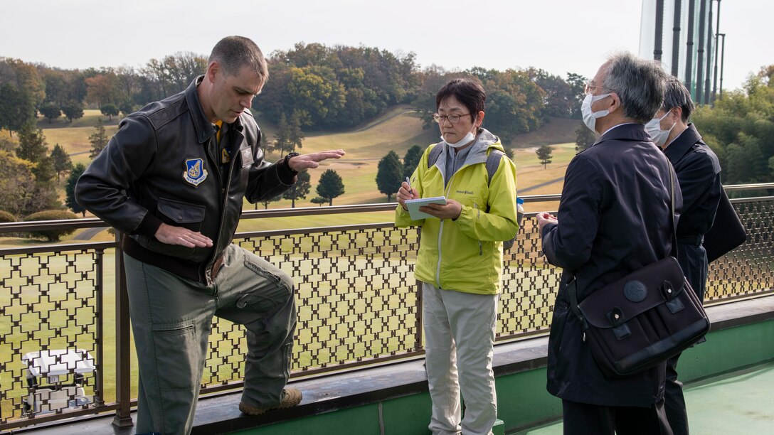 A colonel talks about flying with local Japanese officials.