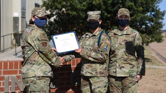 U.S. Air Force Col. Angelina Maguinness, 17th Training Group commander, presents U.S. Space Force Specialist 3 Hannah Powers, 316th Training Squadron student, the 17th TRG Rope of the Month award for October 2021, on Goodfellow Air Force Base, Texas, Nov. 19, 2021. The 316th TRS is responsible for training, developing and inspiring intelligence, surveillance and reconnaissance cryptologic leaders. (U.S. Air Force photo by Airman 1st Class Sarah Williams)