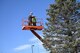 Electricians from the 66th Civil Engineering Division string up the lights for the installation holiday tree outside Outdoor Recreation at Hanscom Air Force Base, Mass., Nov. 18. Base officials will host the annual tree lighting ceremony Dec. 1 at 5 p.m. outside Building 1530, Outdoor Recreation, following a parade through base housing beginning at 3 p.m. (U.S. Air Force photo by Mark Herlihy)