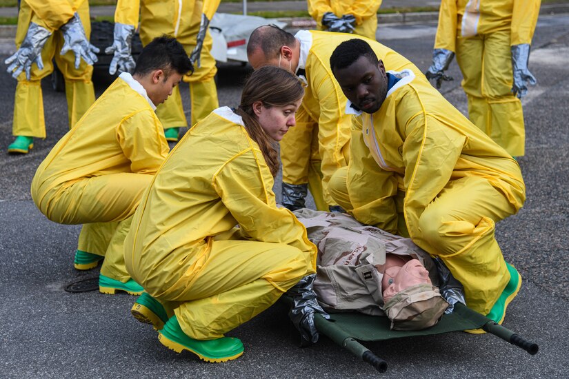 Airmen assigned to the 628th Medical Group lift a simulated patient during a Decontamination Training Exercise at Joint Base Charleston, S.C., Nov. 4, 2021.