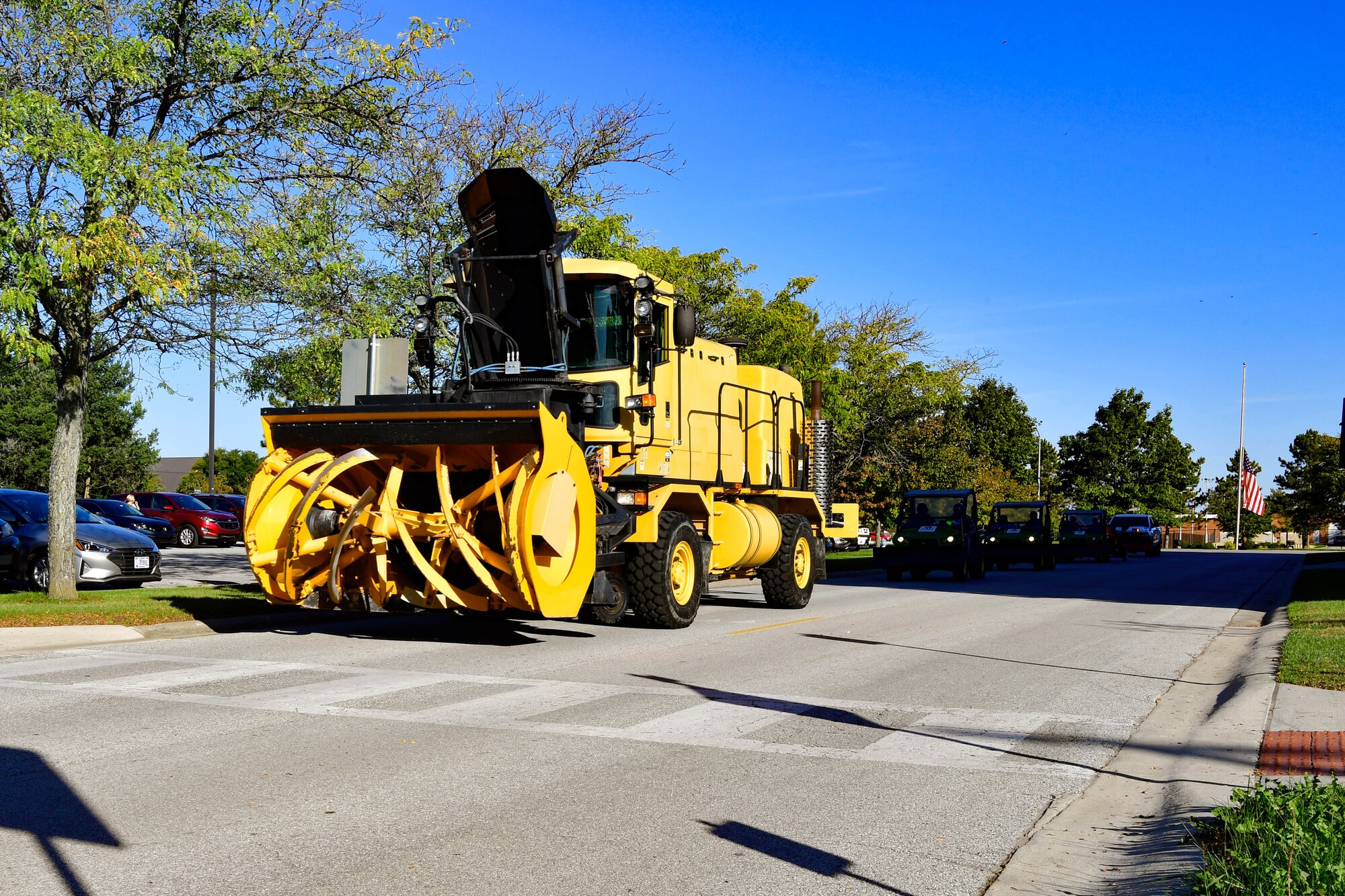 Snow removal vehicles drive through Grissom Air Reserve Base, Indiana on Oct. 19, 2021. Grissom held a Snow Parade to inspect snow removal equipment. (U.S. Air Force photo by Staff Sgt. Jeremy Blocker)