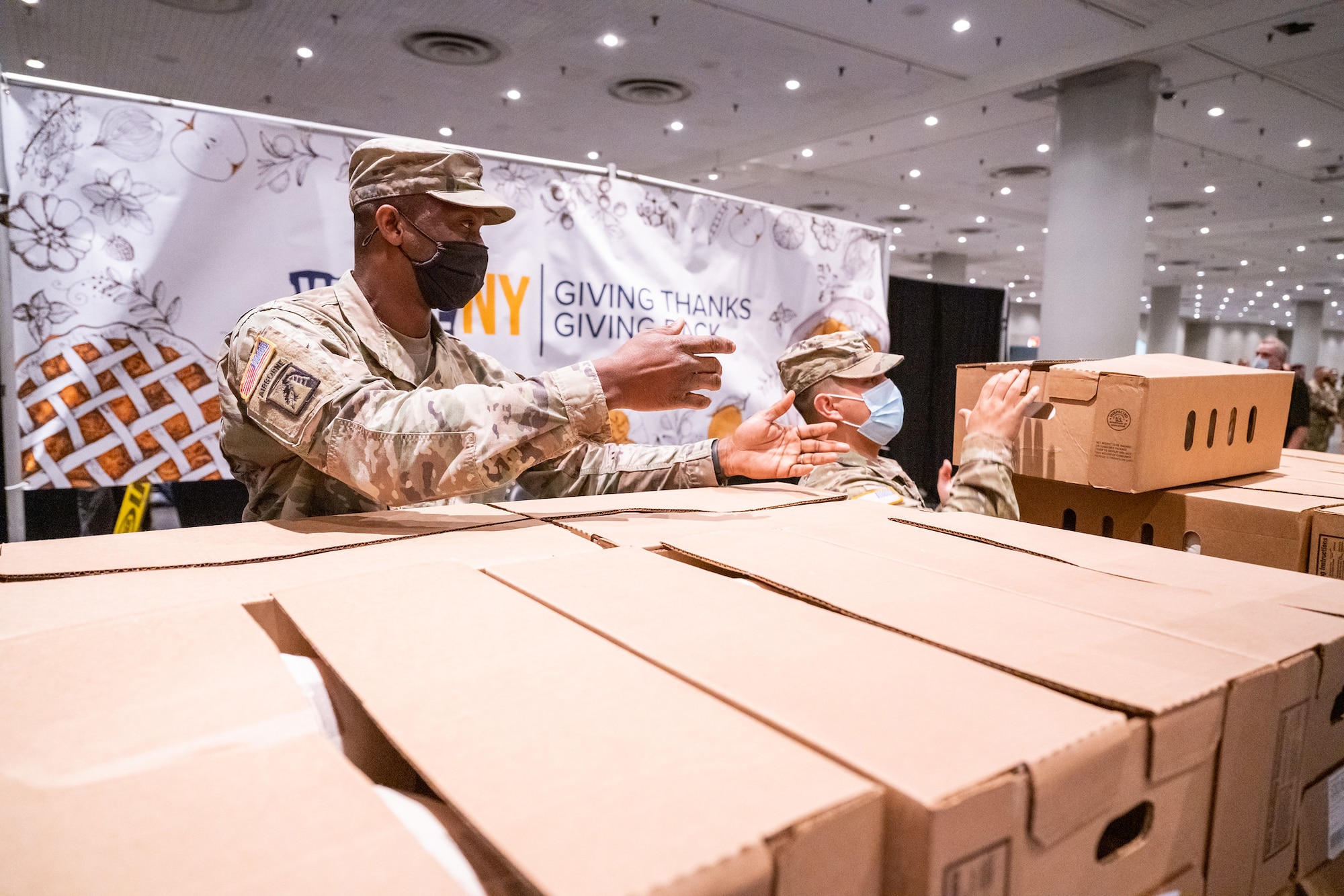 New York National Guard Soldiers and Airmen assigned to Joint Task Force Empire Shield assist in packaging Thanksgiving turkeys for distribution to families across the state at the Jacob Javits Convention Center in New York City November 22, 2021. The New York National Guard provided more than 50 Soldiers and Airmen to assist in the packaging of 3,200 turkeys for families experience food insecurity through the corporate donations of more than $100,000 for the Thanksgiving holiday at food pantries supported by Feed New York State. Photo courtesy of Darren McGee, Office of Governor Kathy Hochul.