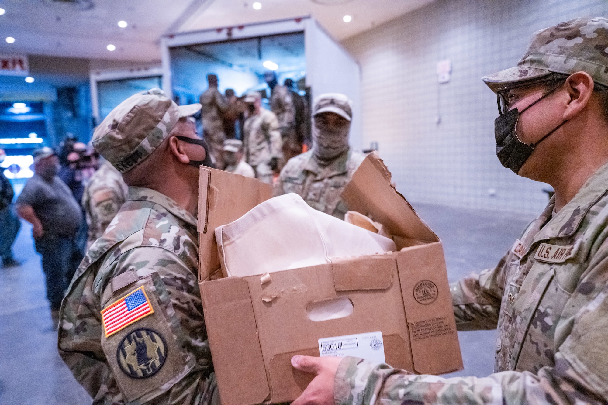 New York National Guard Soldiers and Airmen assigned to Joint Task Force Empire Shield assist in packaging Thanksgiving turkeys for distribution to families across the state at the Jacob Javits Convention Center in New York City November 22, 2021. The New York National Guard provided more than 50 Soldiers and Airmen to assist in the packaging of 3,200 turkeys for families experience food insecurity through the corporate donations of more than $100,000 for the Thanksgiving holiday at food pantries supported by Feed New York State. Photo courtesy of Darren McGee, Office of Governor Kathy Hochul.