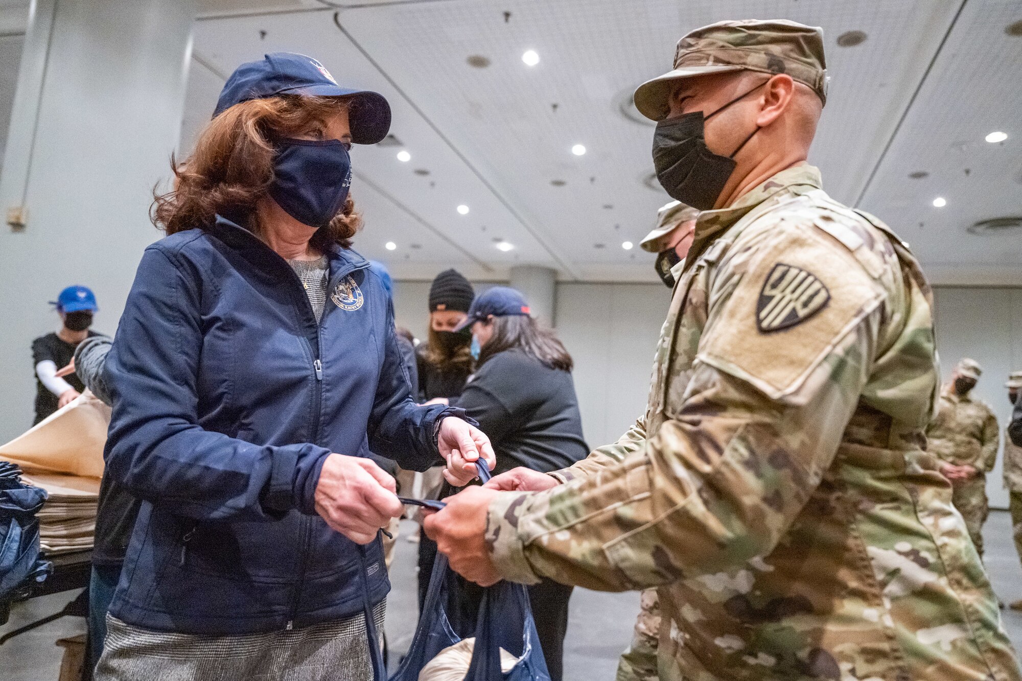 New York Governor Kathy Hochul assists New York Army National Guard Staff Sgt. Danny CalladoEstevez in packaging Thanksgiving turkeys for distribution to families across the state at the Jacob Javits Convention Center in New York City November 22, 2021. The New York National Guard provided more than 50 Soldiers and Airmen to assist in the packaging of 3,200 turkeys for families experiencing food insecurity through the corporate donations of more than $100,000 for the Thanksgiving holiday at food pantries supported by Feed New York State. Photo courtesy of Darren McGee, Office of Governor Kathy Hochul.
